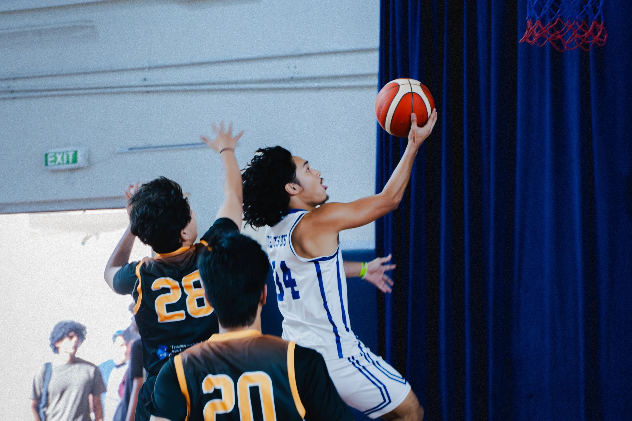 Basketball players contesting a shot