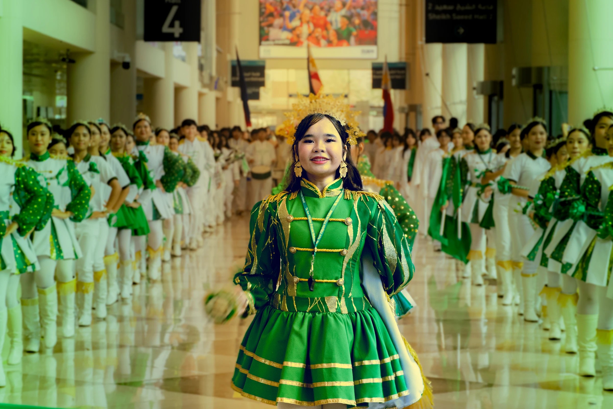 PID participant in green with a group in traditional dress