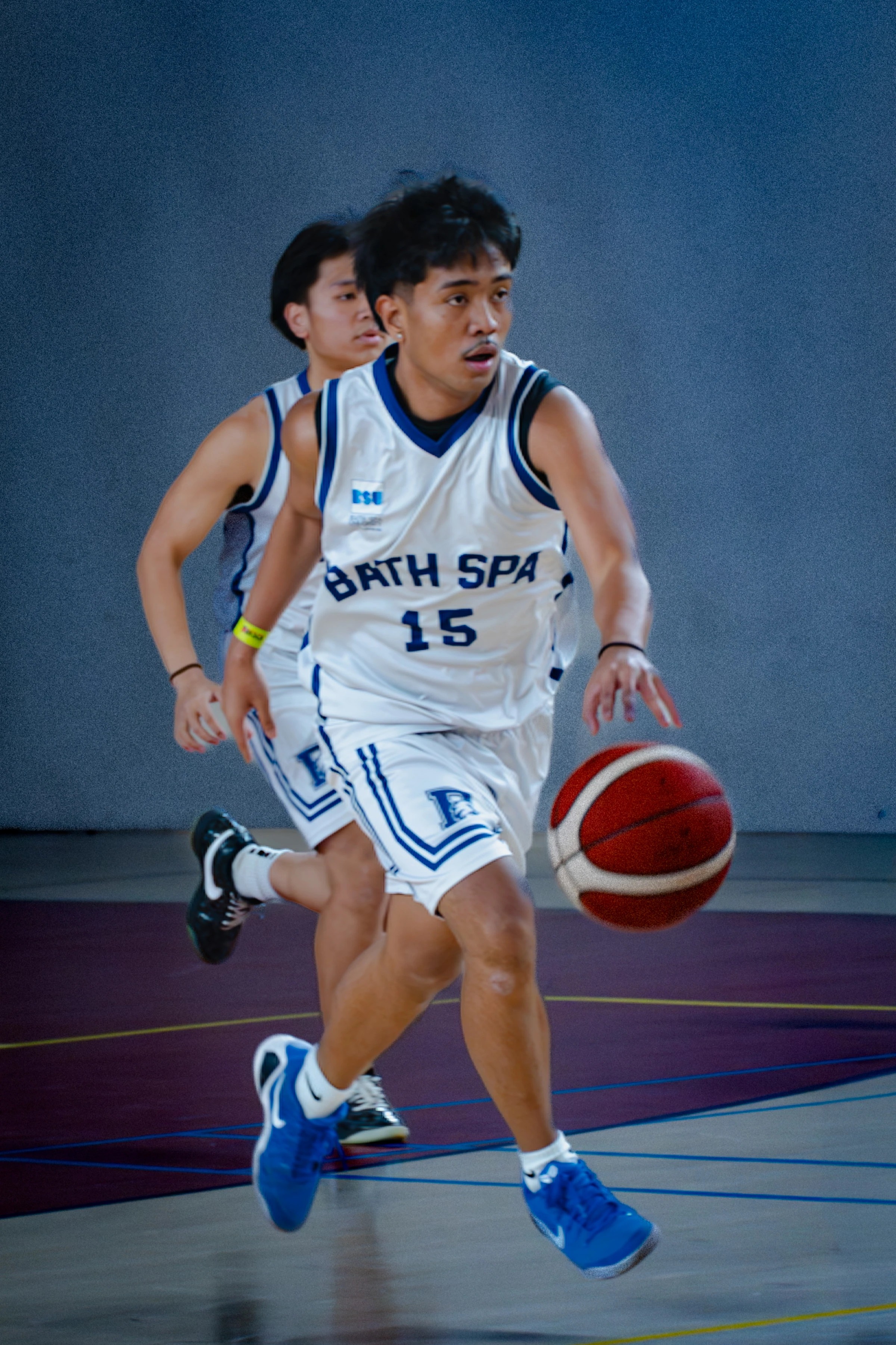 Basketball player dribbling up court