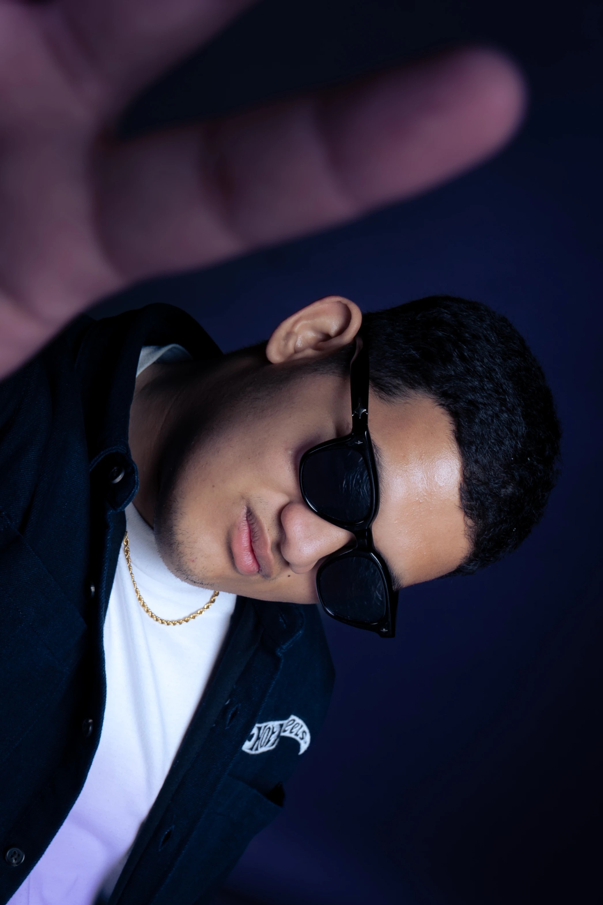 Portrait of Lance Miranda wearing sunglasses and a dark jacket