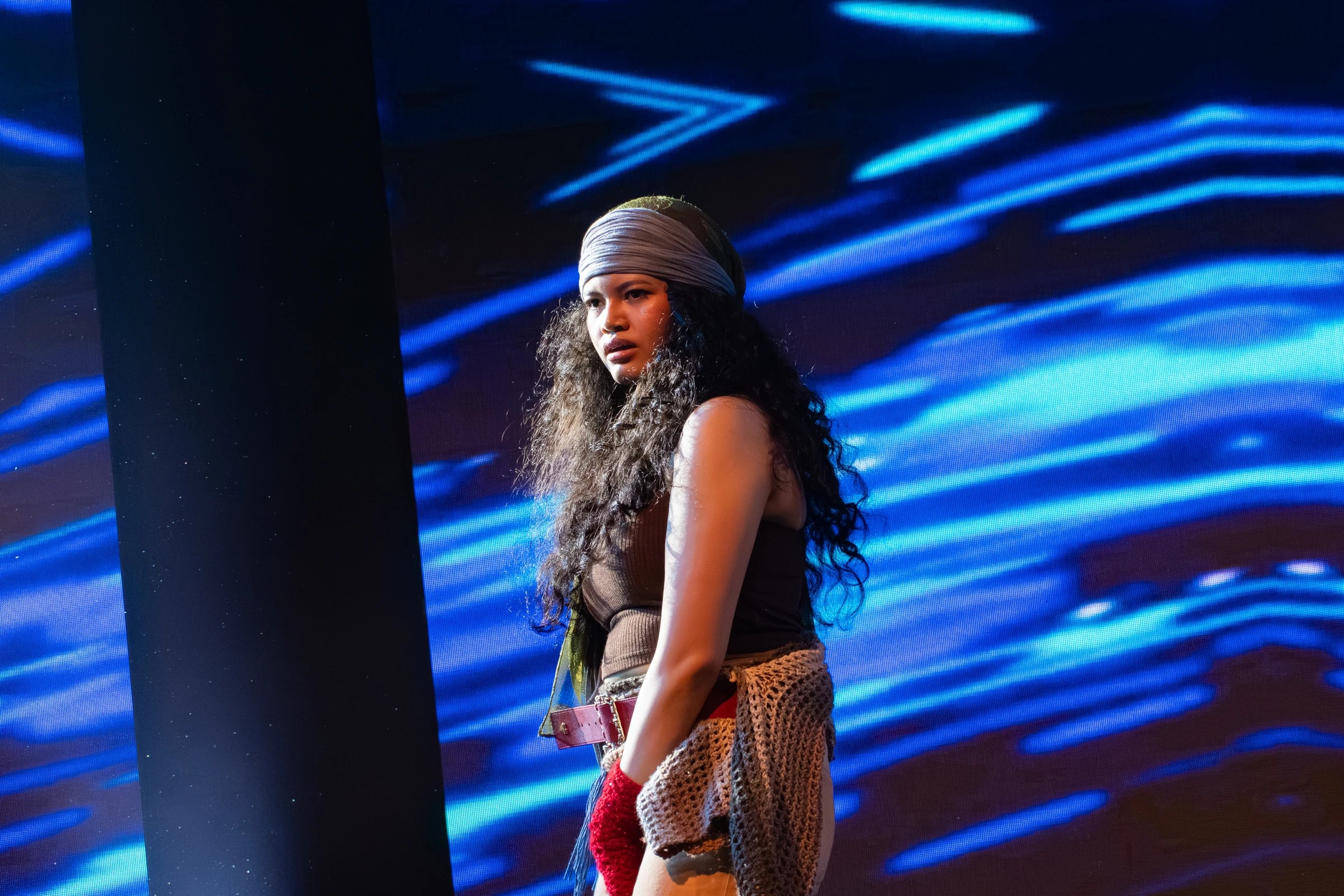Kalayaan performer against blue stage lighting