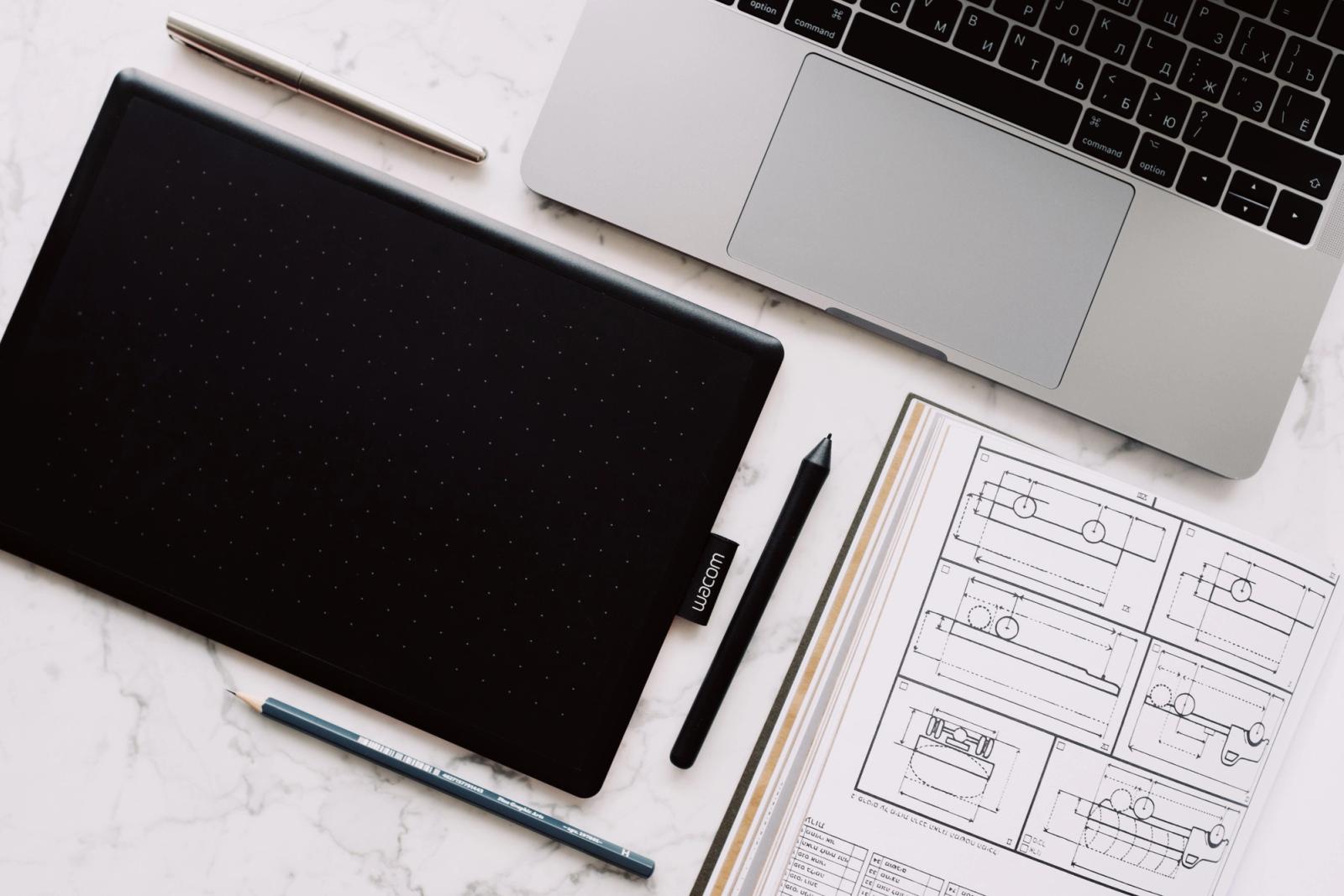 Laptop and drawing tablet in a creative design workspace