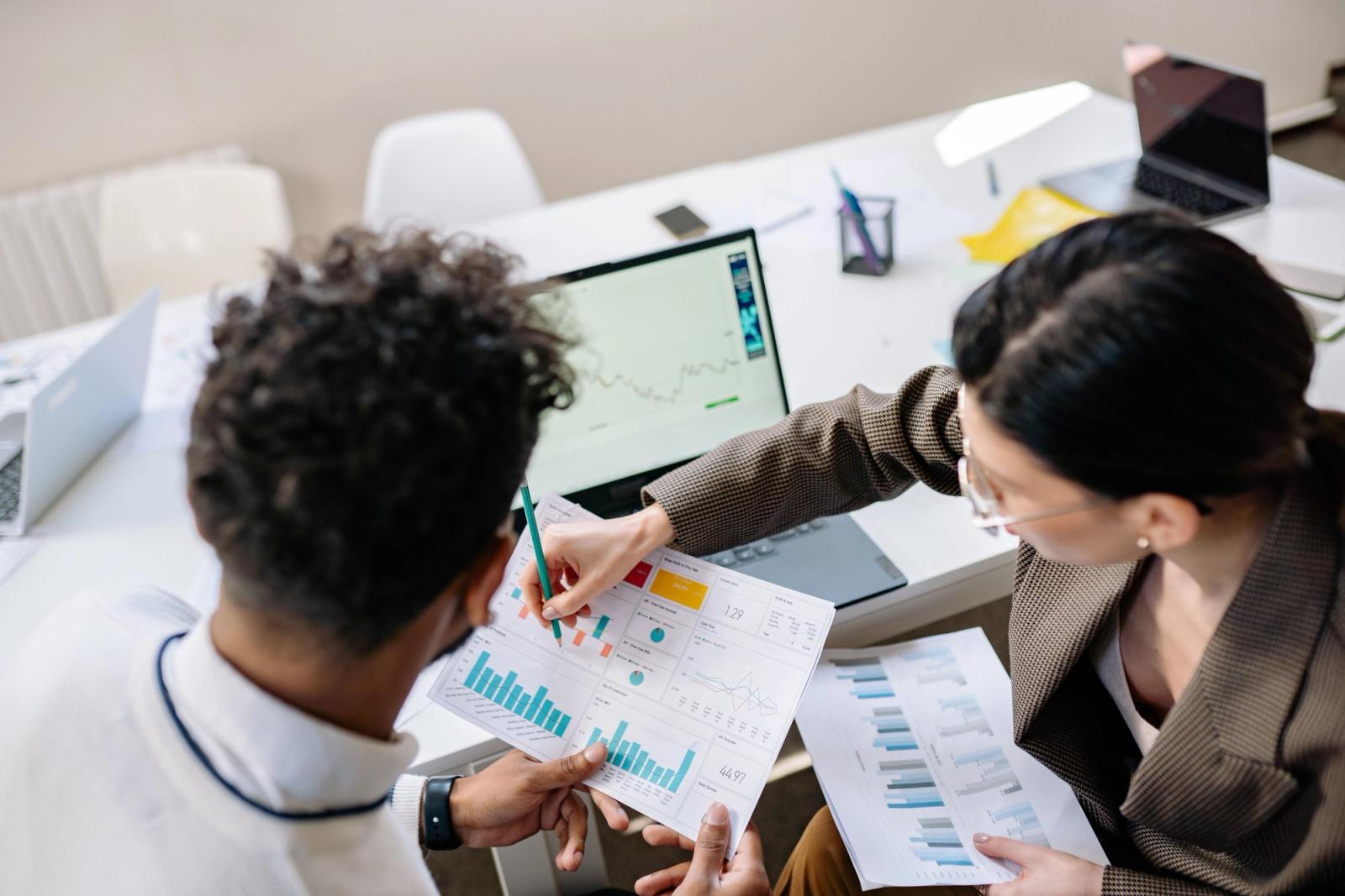 Colleagues reviewing charts for a CRM platform comparison
