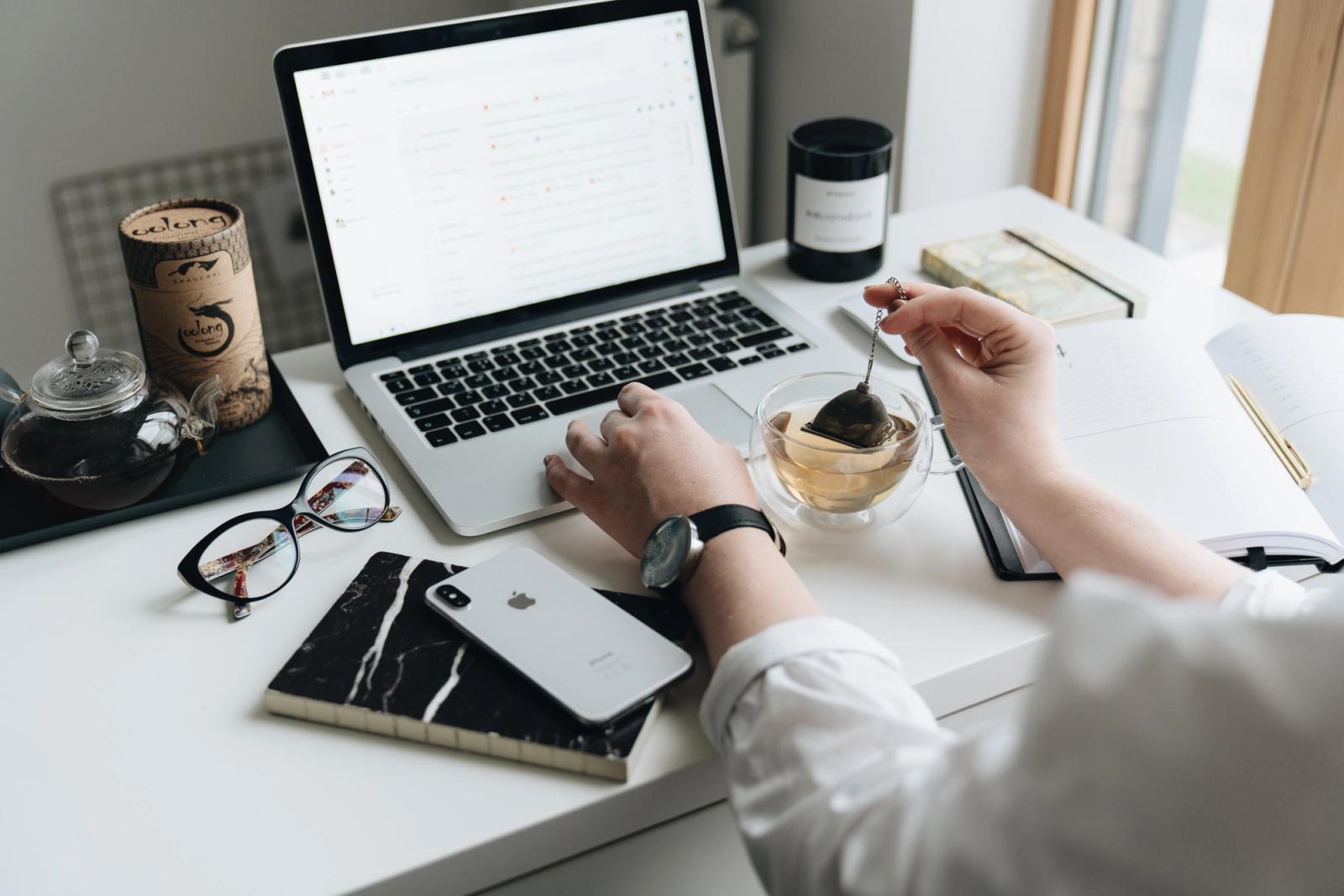 Laptop and tea in a cozy professional email marketing workspace