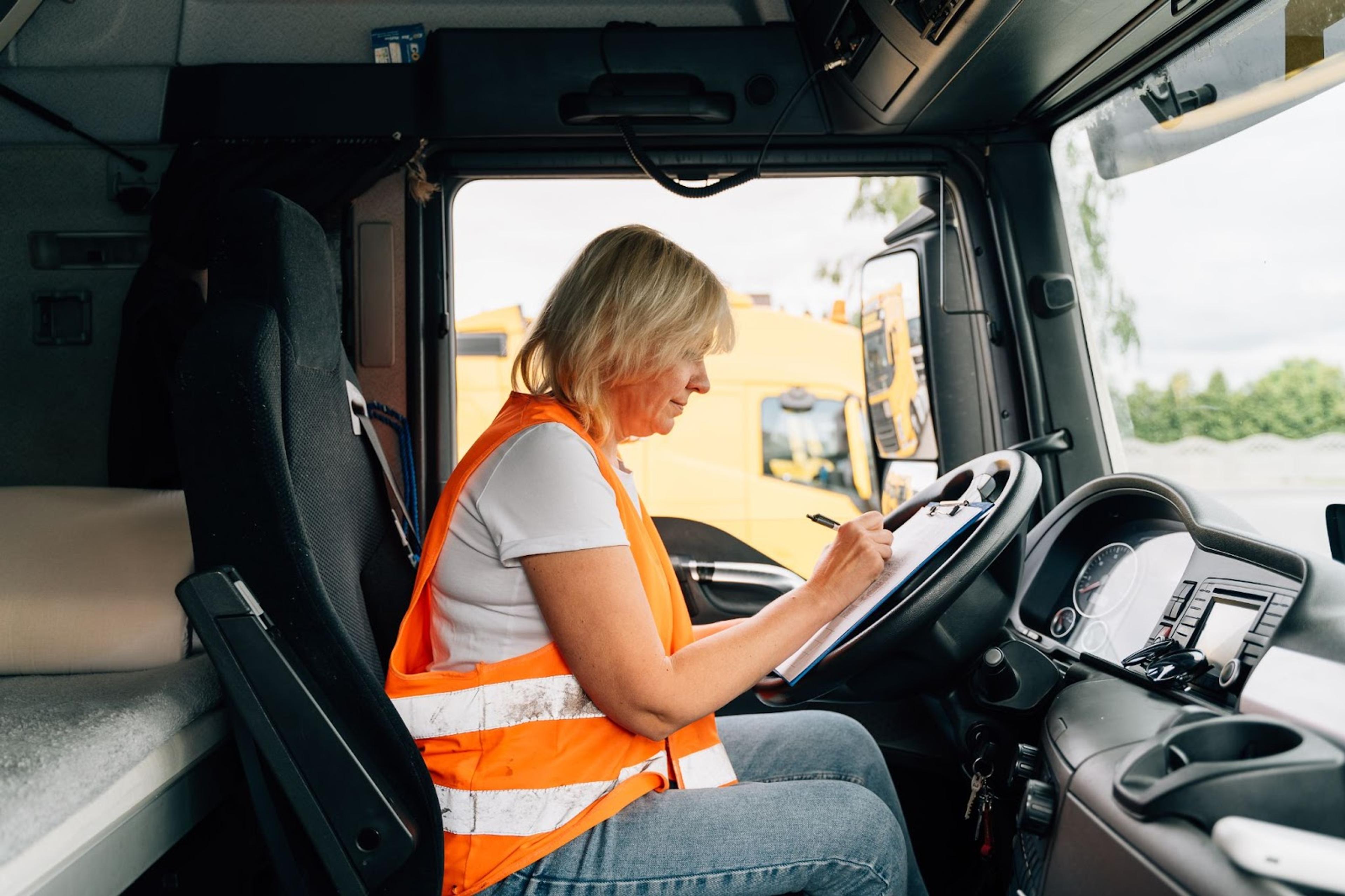 A Woman Filling Out a Form For A Trucking Job