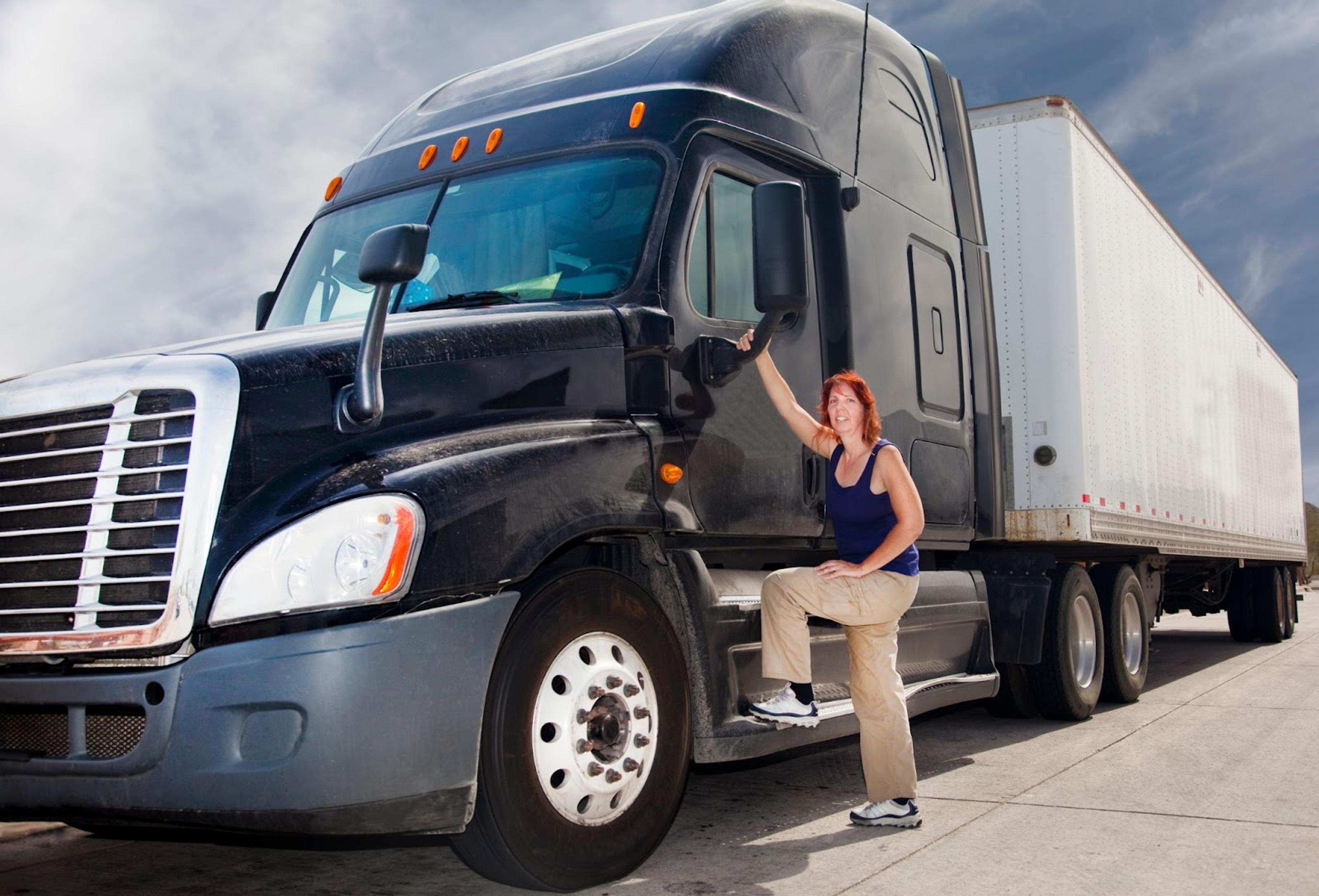 A Woman soon to enter into a semi-truck to begin driving.