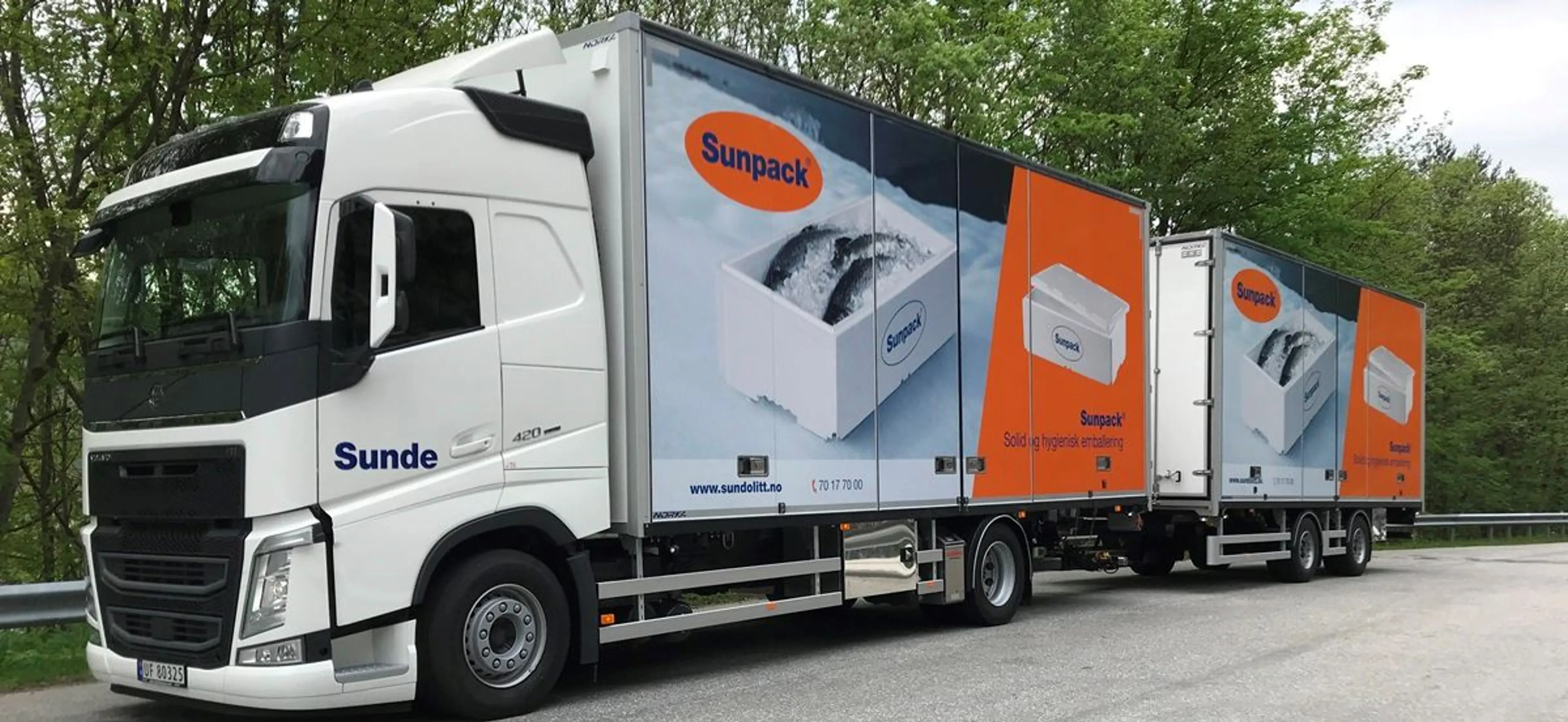 Billedet viser en Sunde lastbil med Sunpack logoer og fiskekasser i EPS på siden samt den kendte orange farve