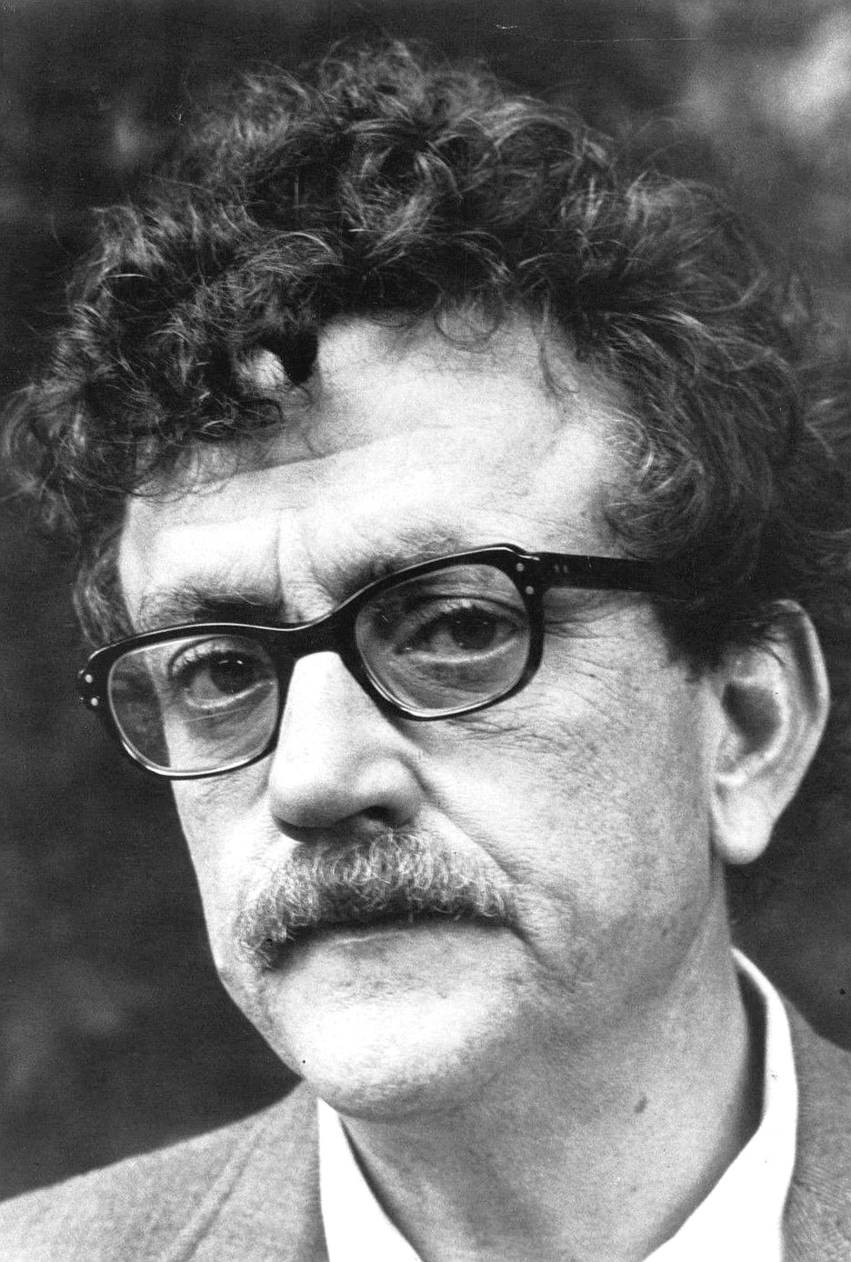 Black-and-white portrait of Kurt Vonnegut wearing glasses and having a moustache upsettingly similar to my father's.