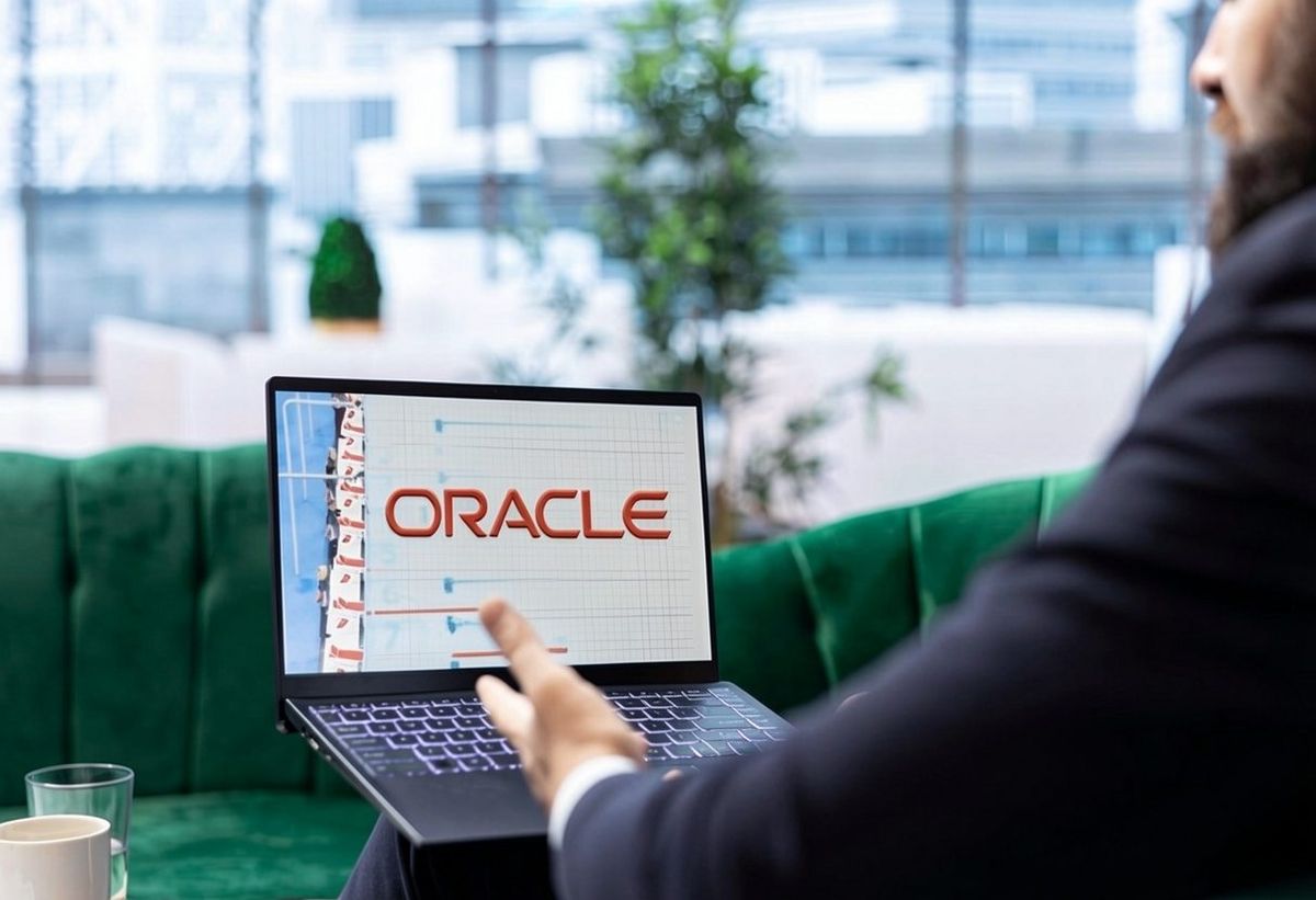Business professional viewing the Oracle platform on a laptop