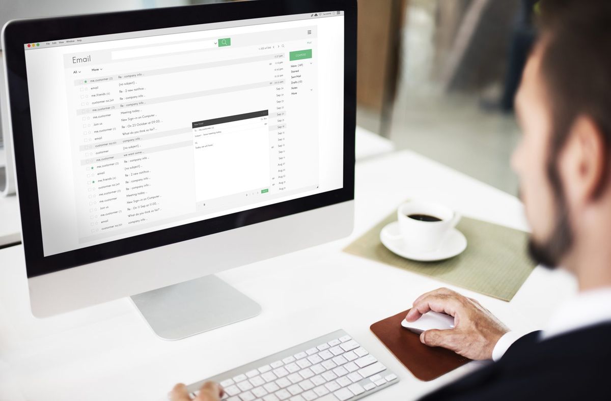 Business professional reviewing email in an executive office