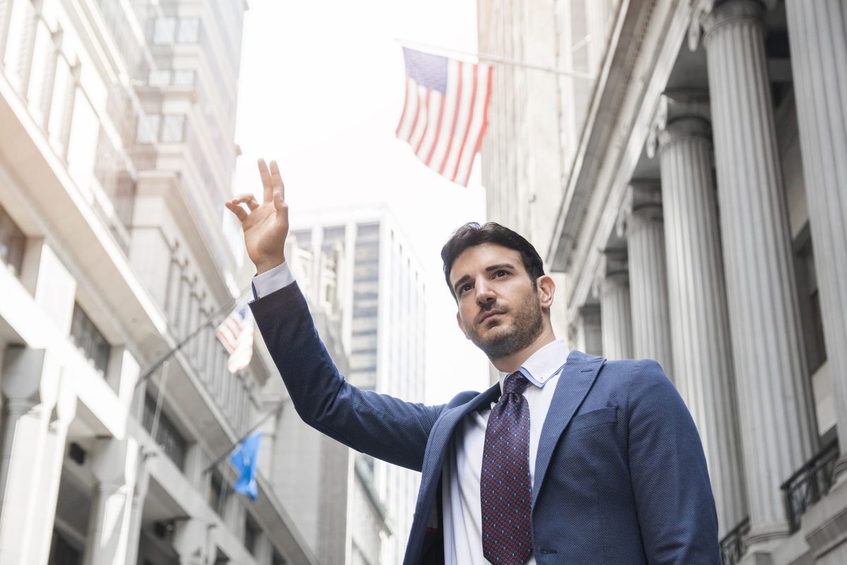 Business professional on Wall Street with the American flag