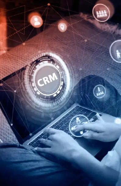 CRM platform connecting customer records over a laptop