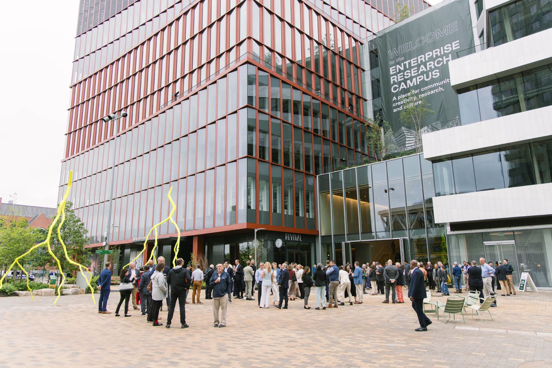 The image shows the official opening celebration of One Milestone at Harvard University's Enterprise Research Campus (ERC) in Allston, Massachusetts, which marked the completion of the project's first phase in June 2026.