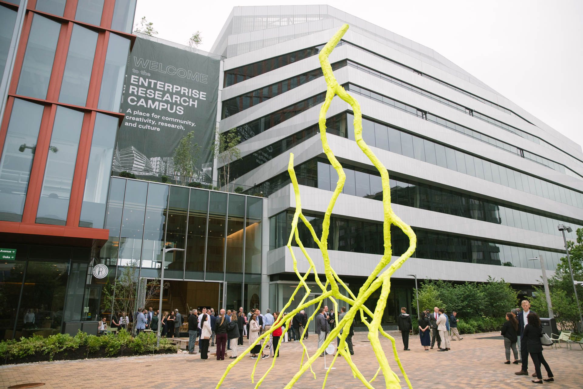 The image shows the newly opened Phase One of Harvard's Enterprise Research Campus in Allston, Boston. This initial phase includes mixed-use life science and research buildings developed in partnership with Tishman Speyer.