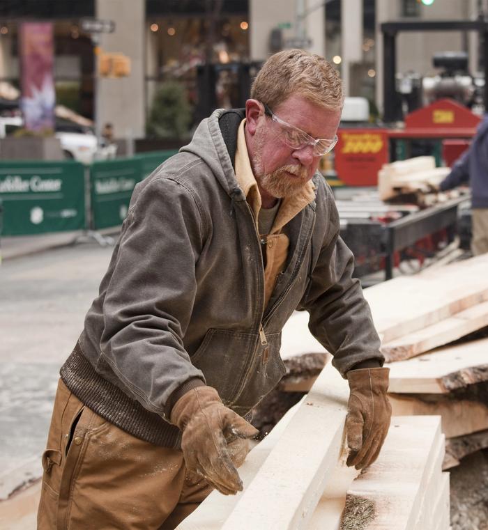 Man milling the Rockefeller Center Christmas Tree into lumber