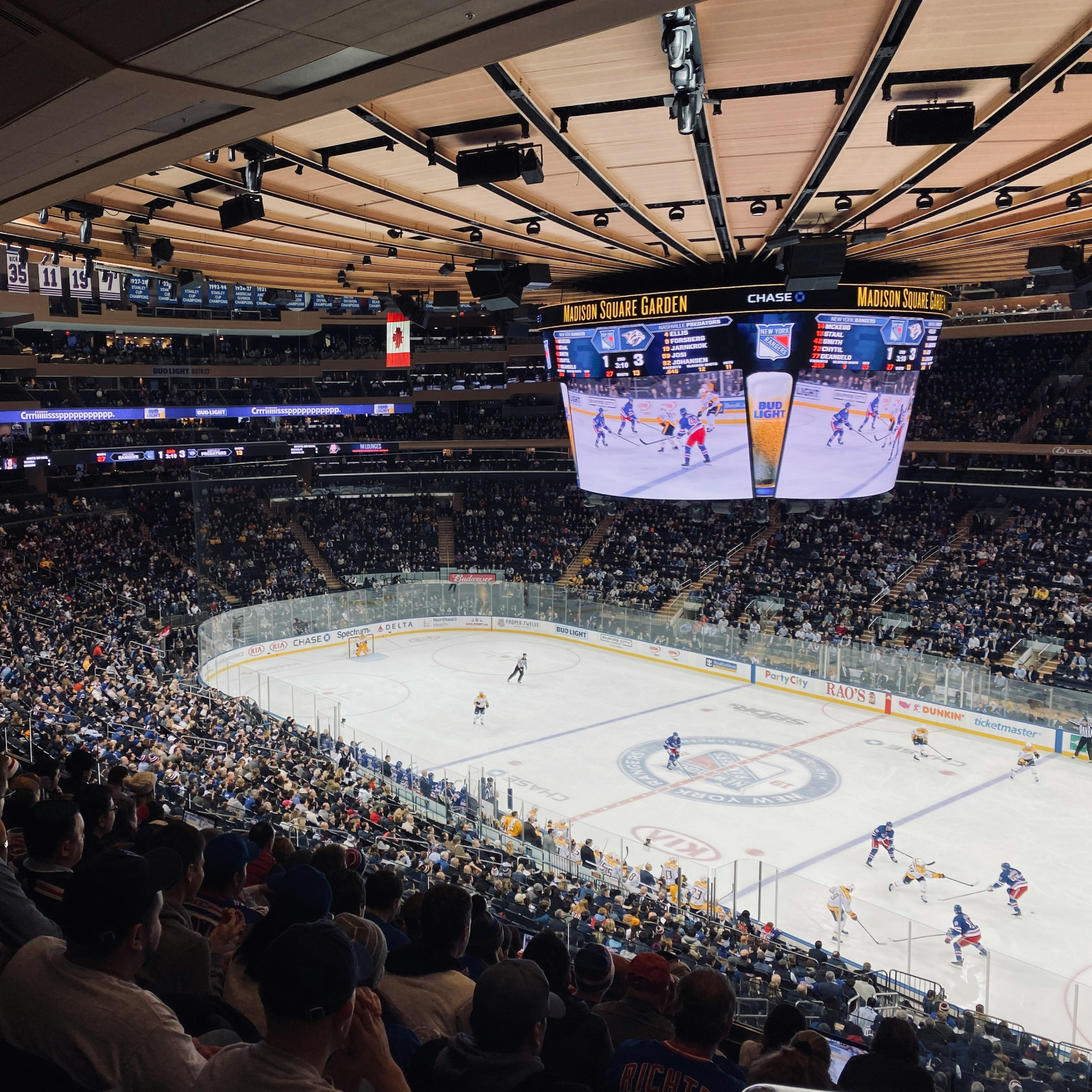 A large crowd of people watching the New York Rangers at Madison Square Garden