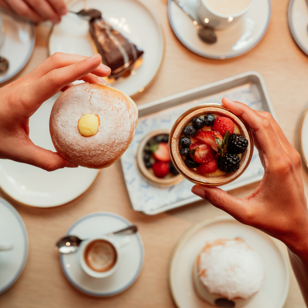 Two hands holding pastries from Eataly Caffé at Rockefeller Center