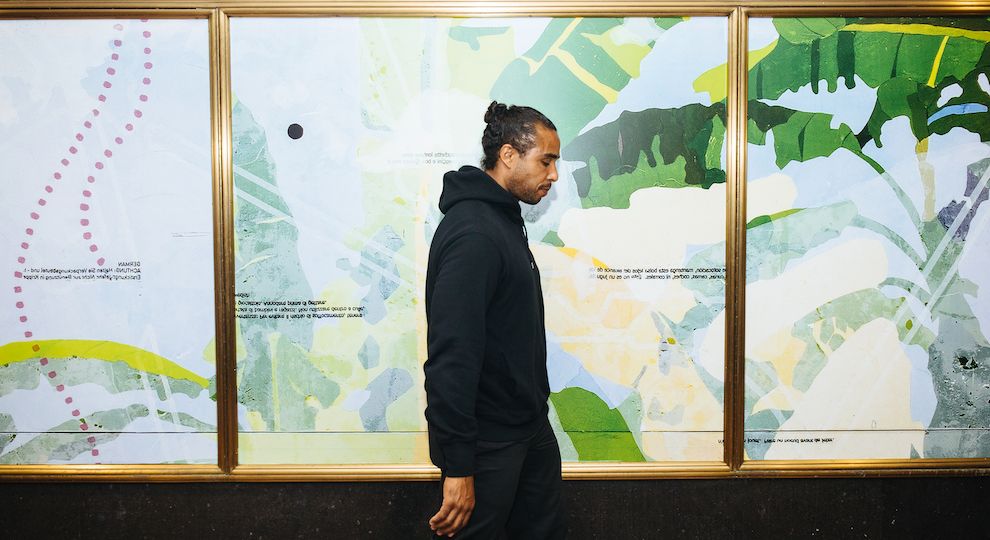 Artist Hugo McCloud stands in front of his artwork on display at Rockefeller Center