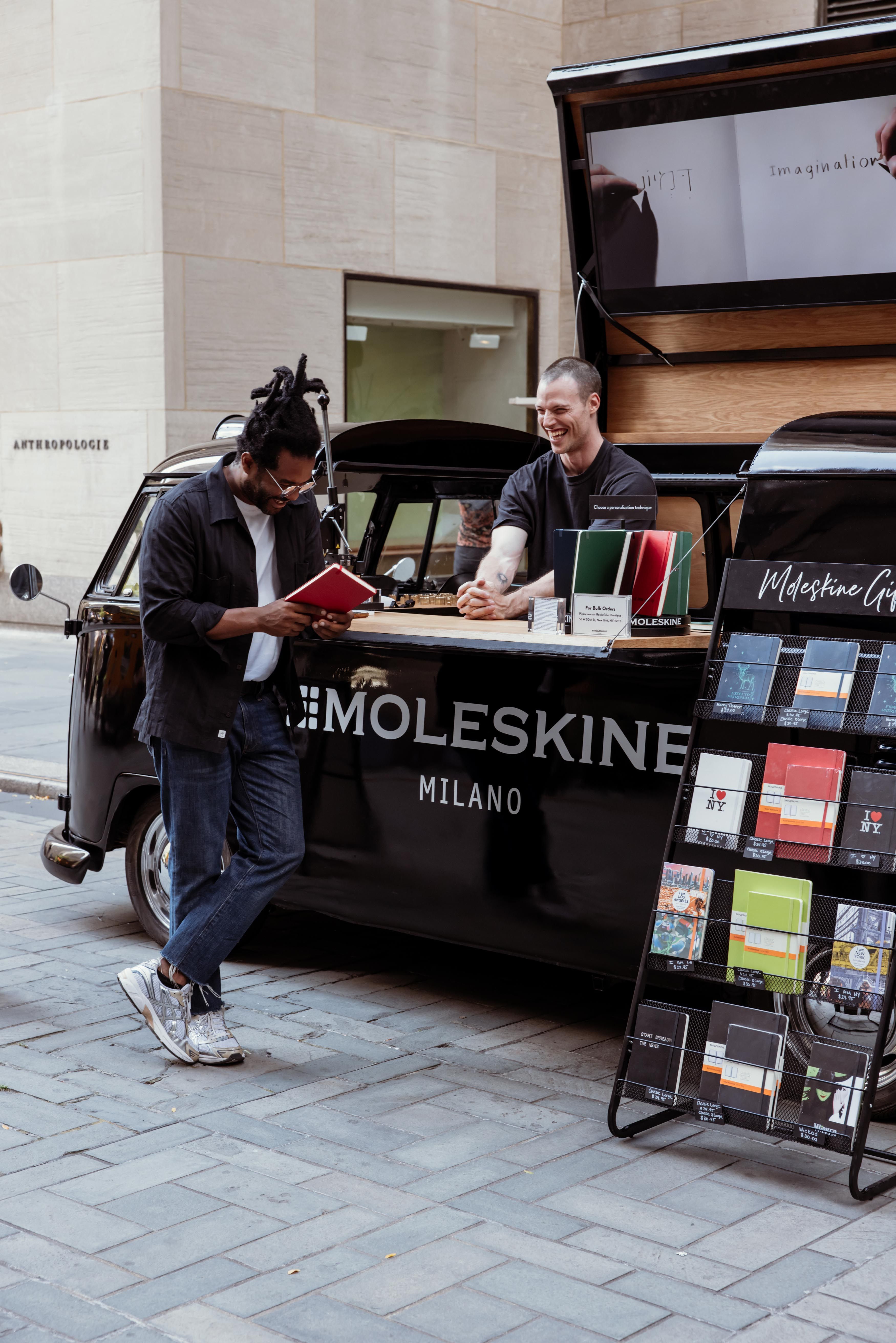 two men talking at the Moleskine truck