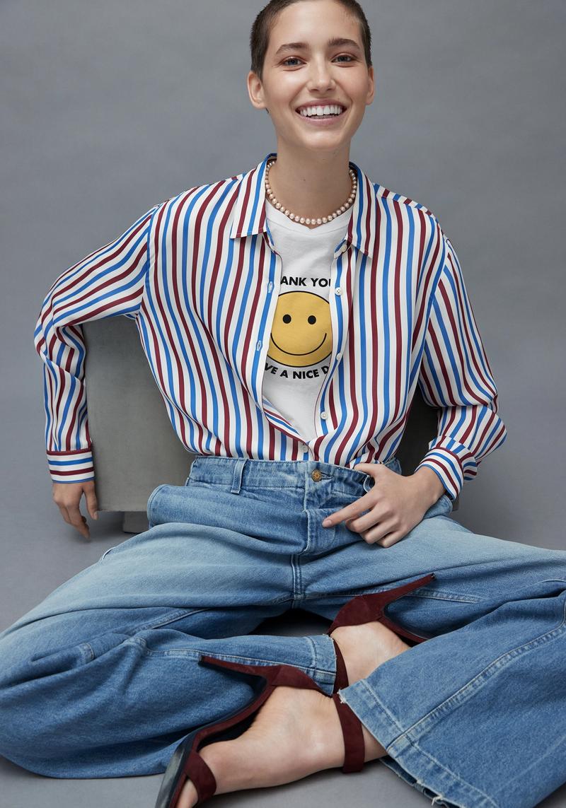 Model in a Kule t-shirt and printed button down