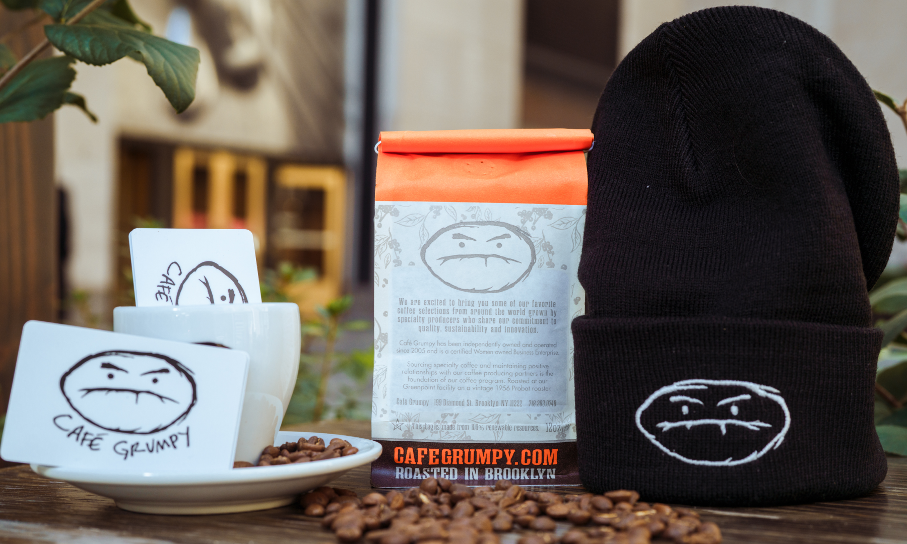 A gift card, bag of coffee beans, and hat from Café Grumpy at Rockefeller Center