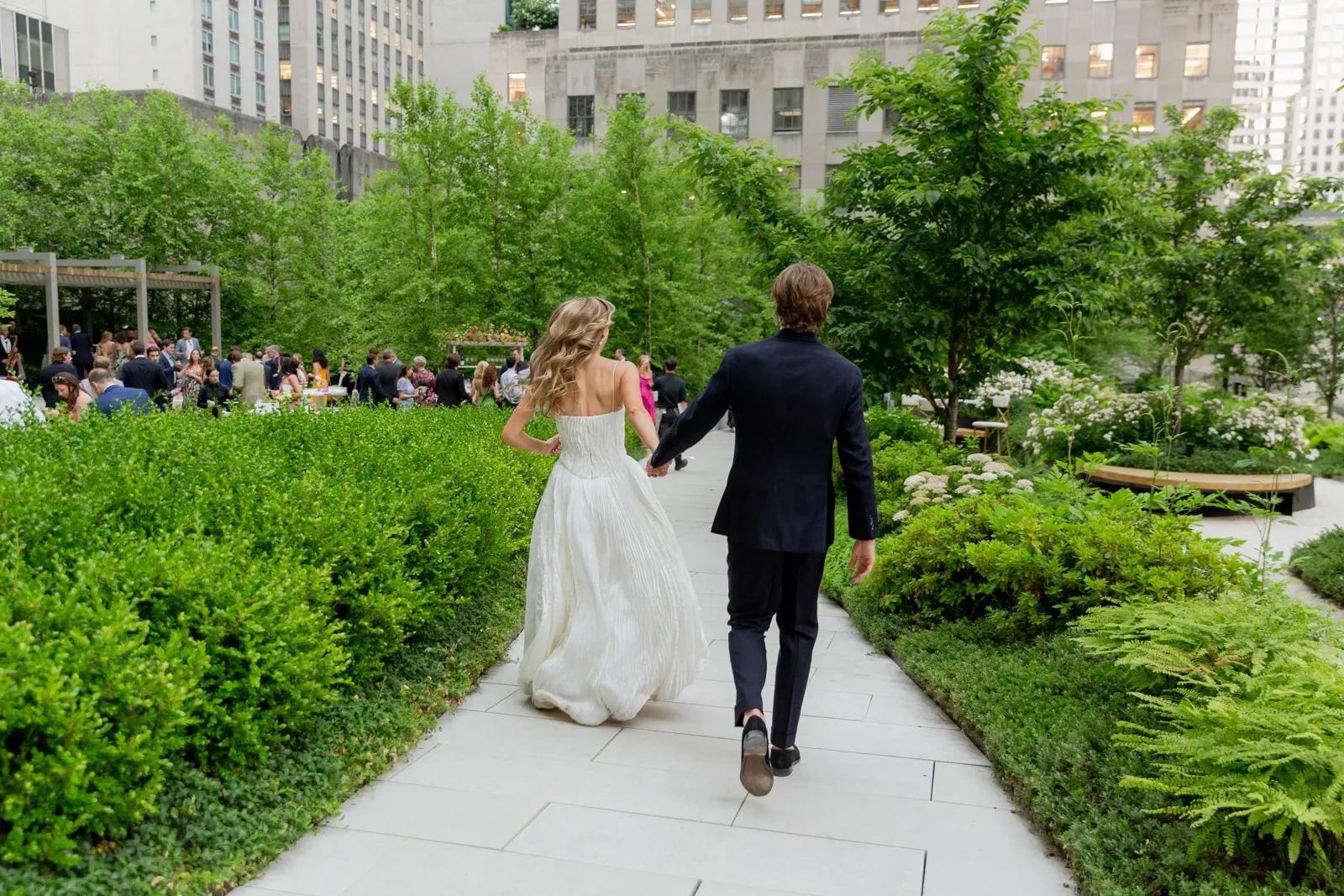 Bride and groom holding hands at Radio Park