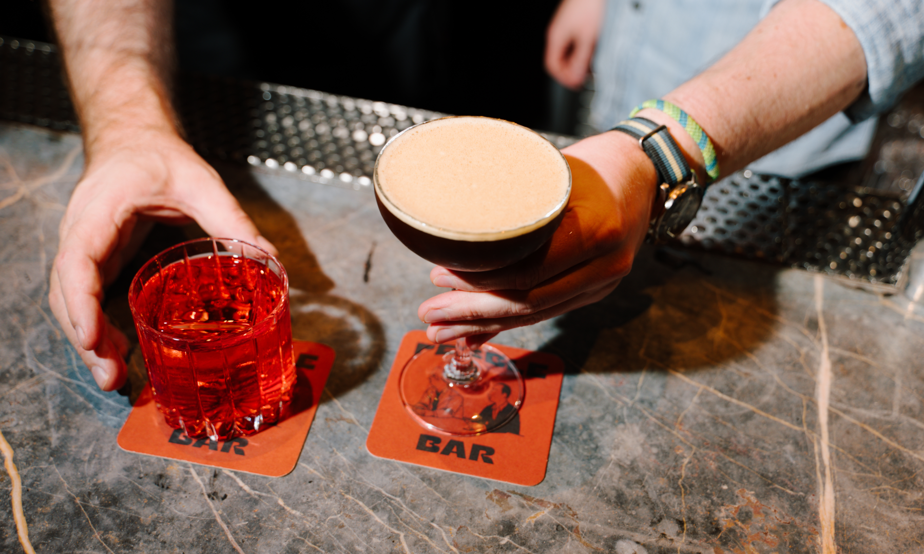two craft cocktails being served
