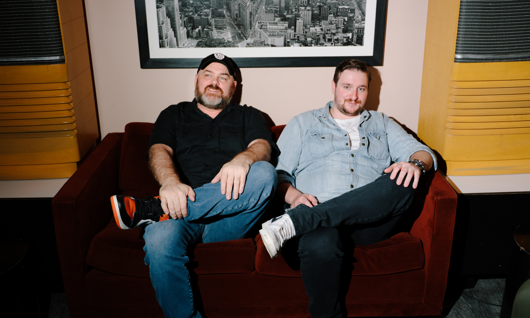bartenders relaxing on a red sofa