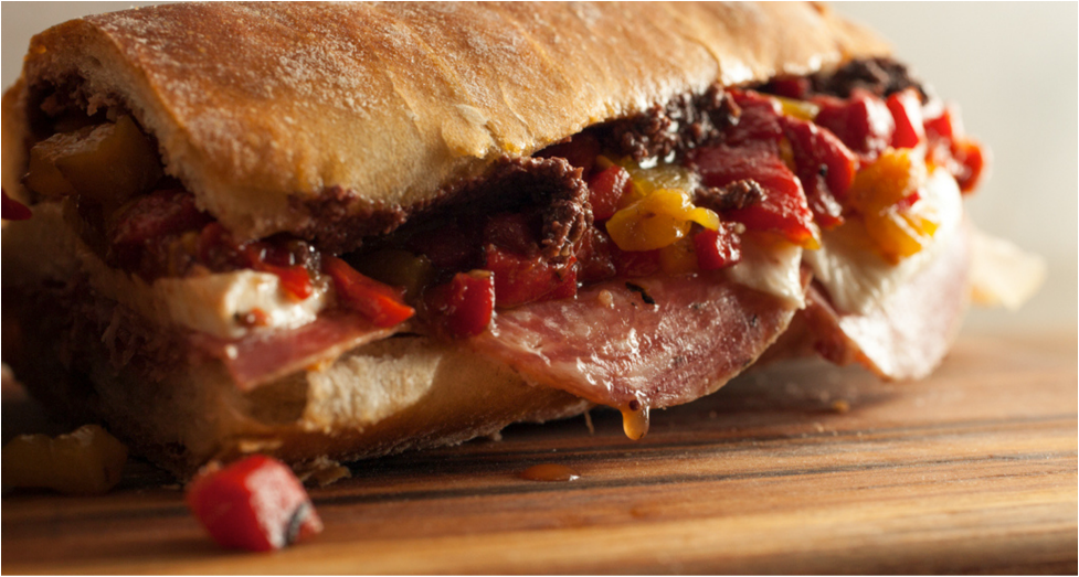 Alidoro deli sandwich with various meats, cheese, and peppers