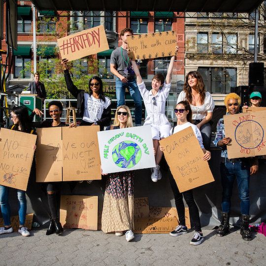 People holding signs at the Earth Day festival in Union Square