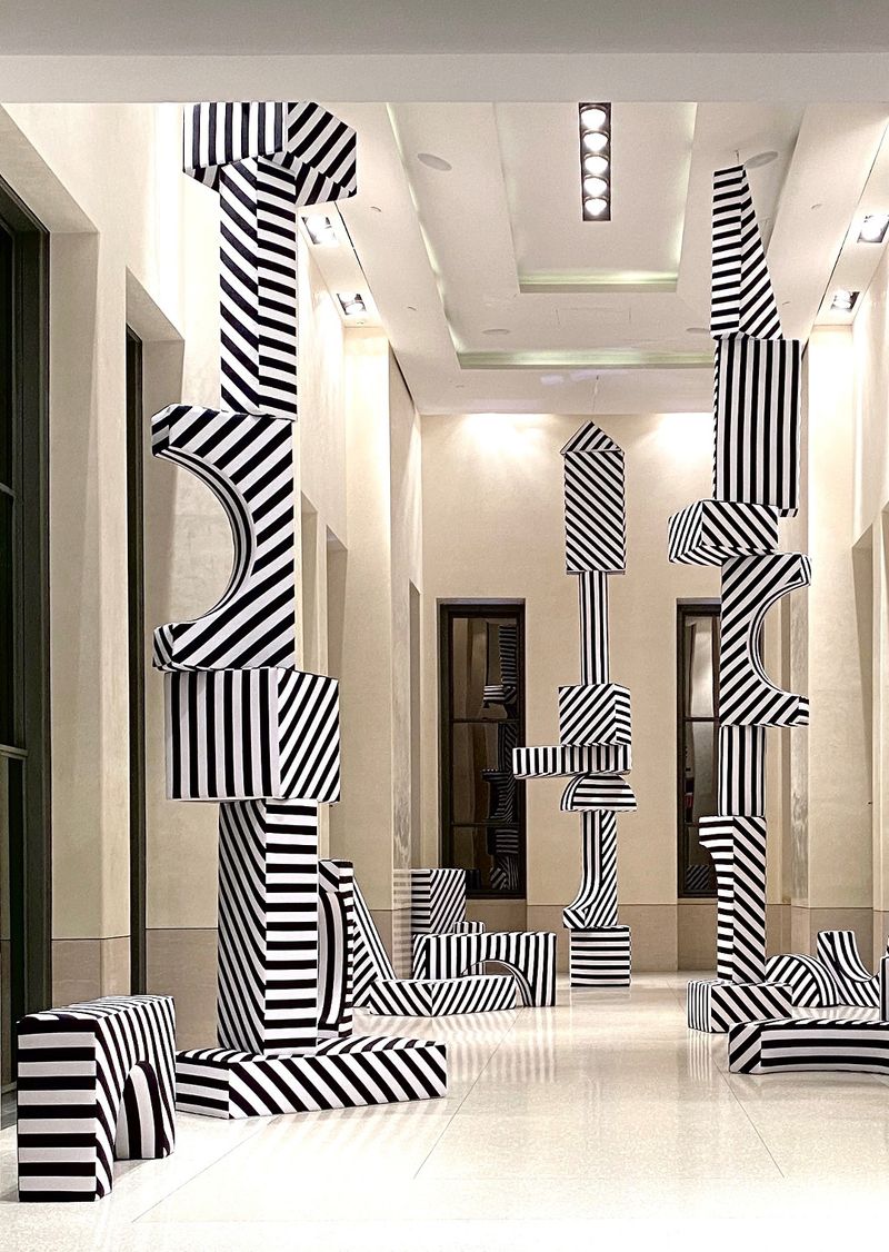 Photo of large black and white striped sculptures that make up the Buildings and Blocks installation at Top of the Rock.