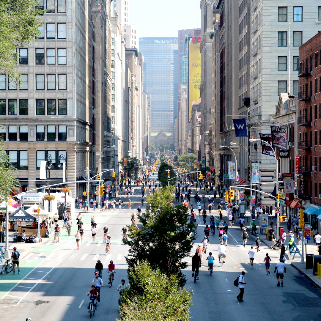 Large group of New Yorkers walking in the middle of the street during Summer Streets