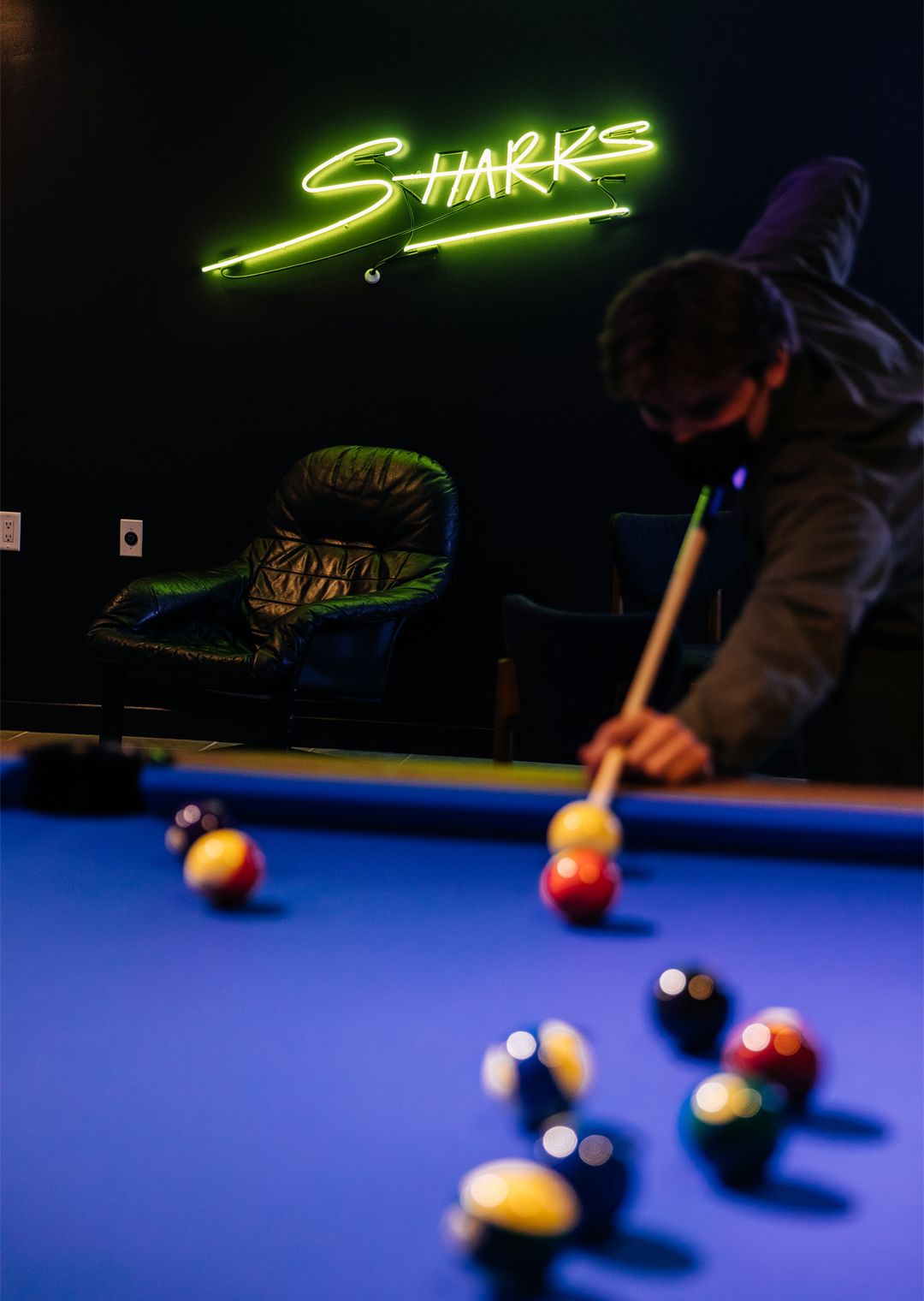 Sharks Pool Club, person playing pool