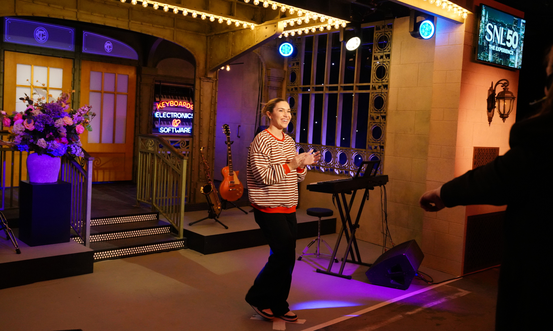 Woman participating as a Saturday Night Live host at the 'Live from New York: The SNL50 Experience'