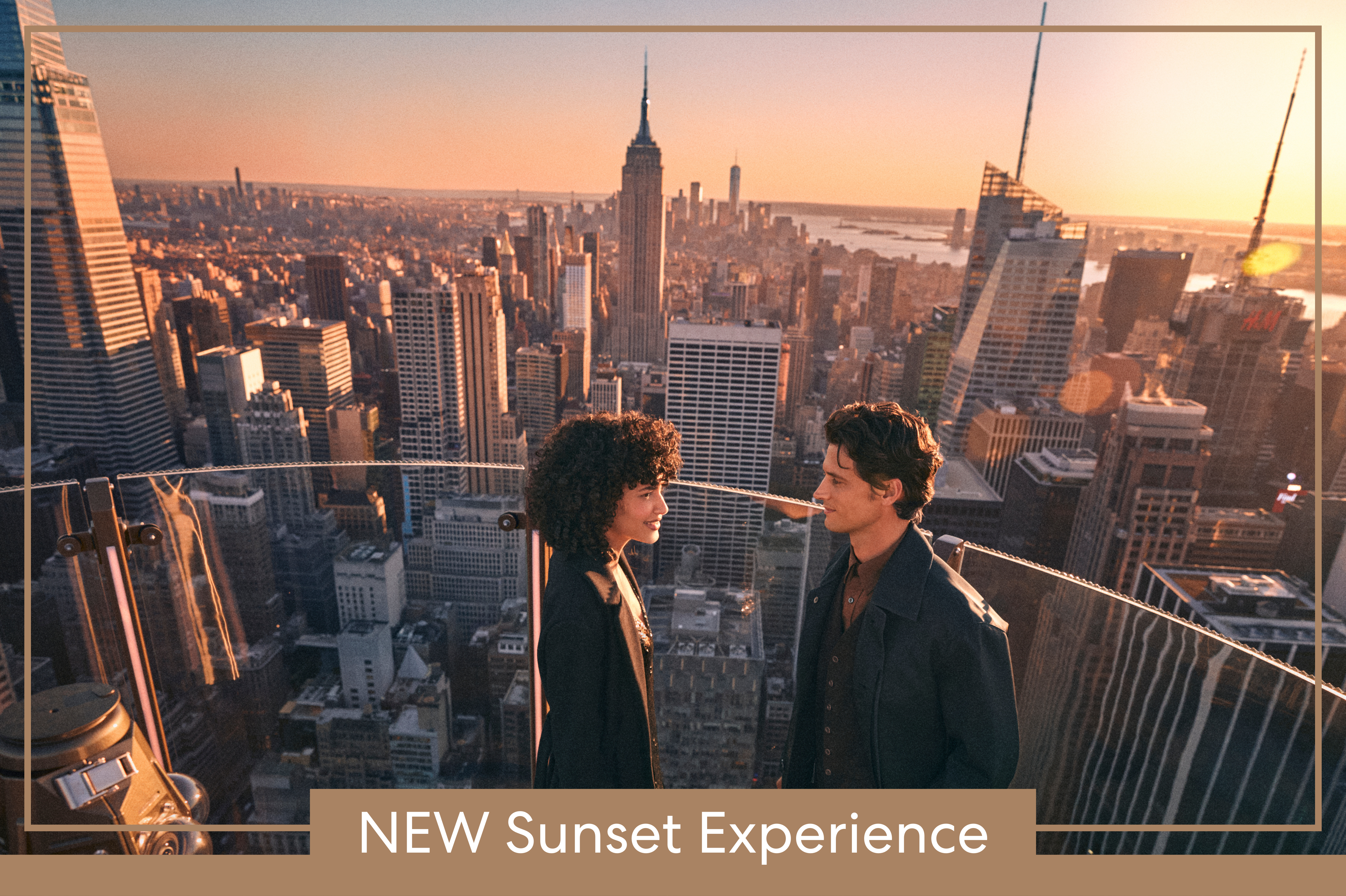 a couple looking at each other with the sunset skyline behind them