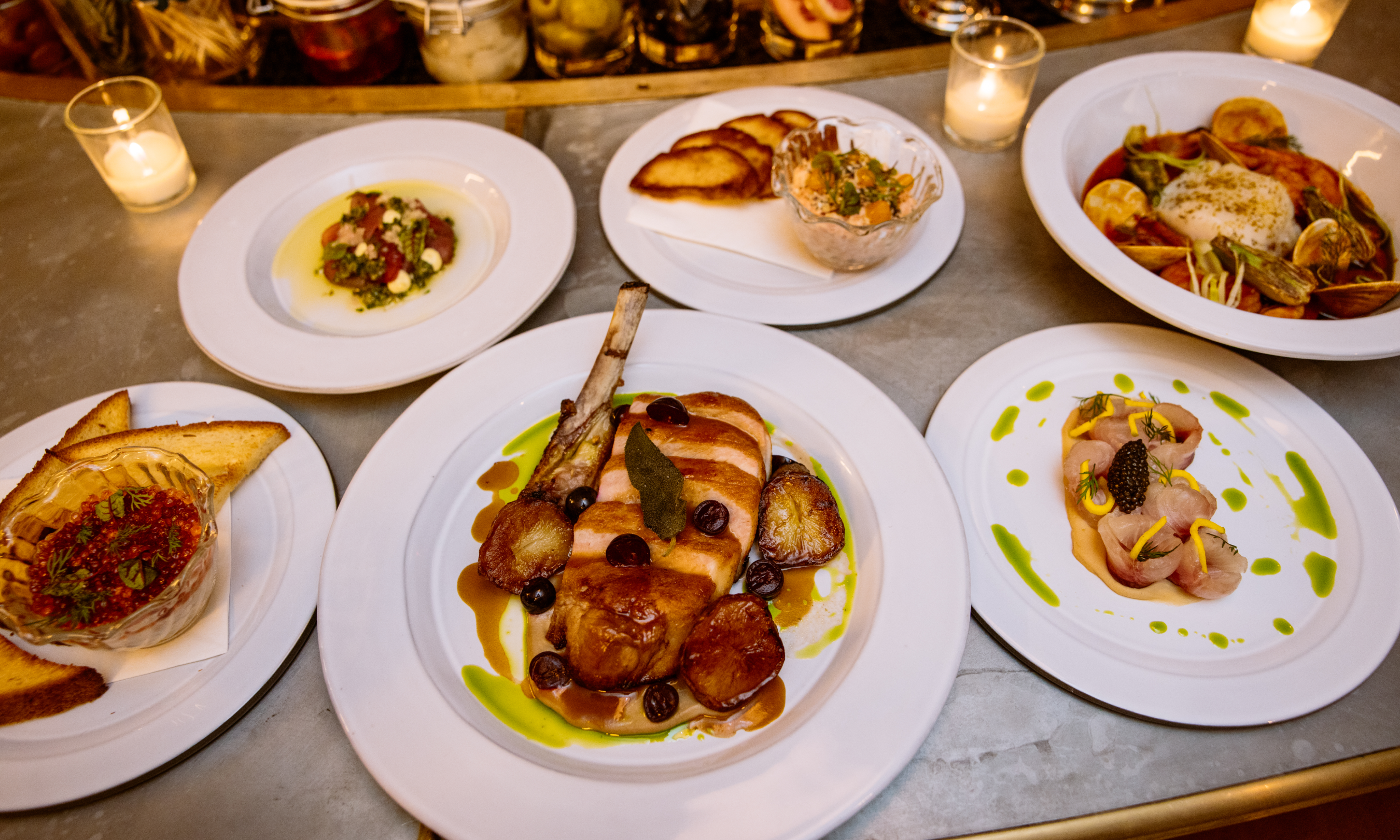 Plates of food placed on the bar at Smith & Mills