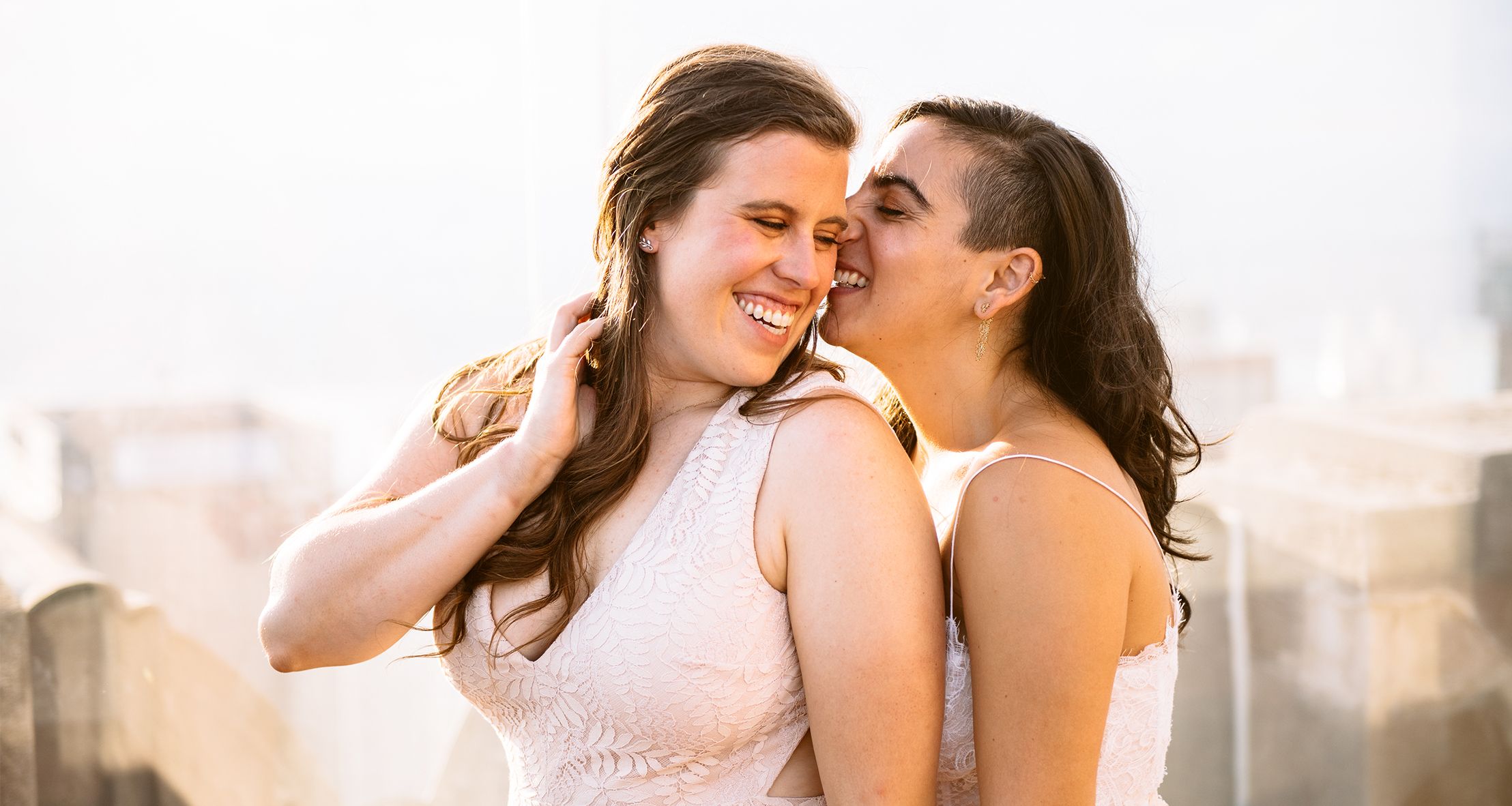 Chelsea and Mia posed at Top of the Rock on their wedding day