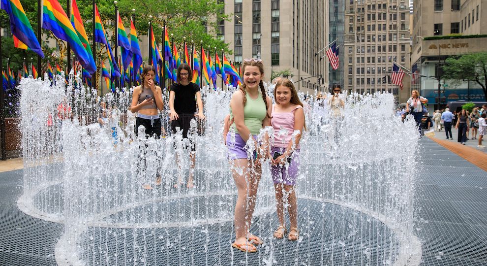 Two children playing with artist Jeppe Hein's "Changing Spaces" installation at Rockefeller Center