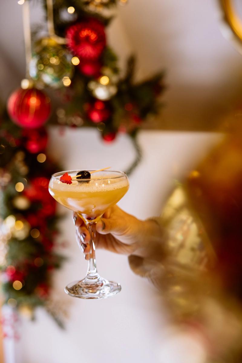 Drink being held in front of Christmas decor