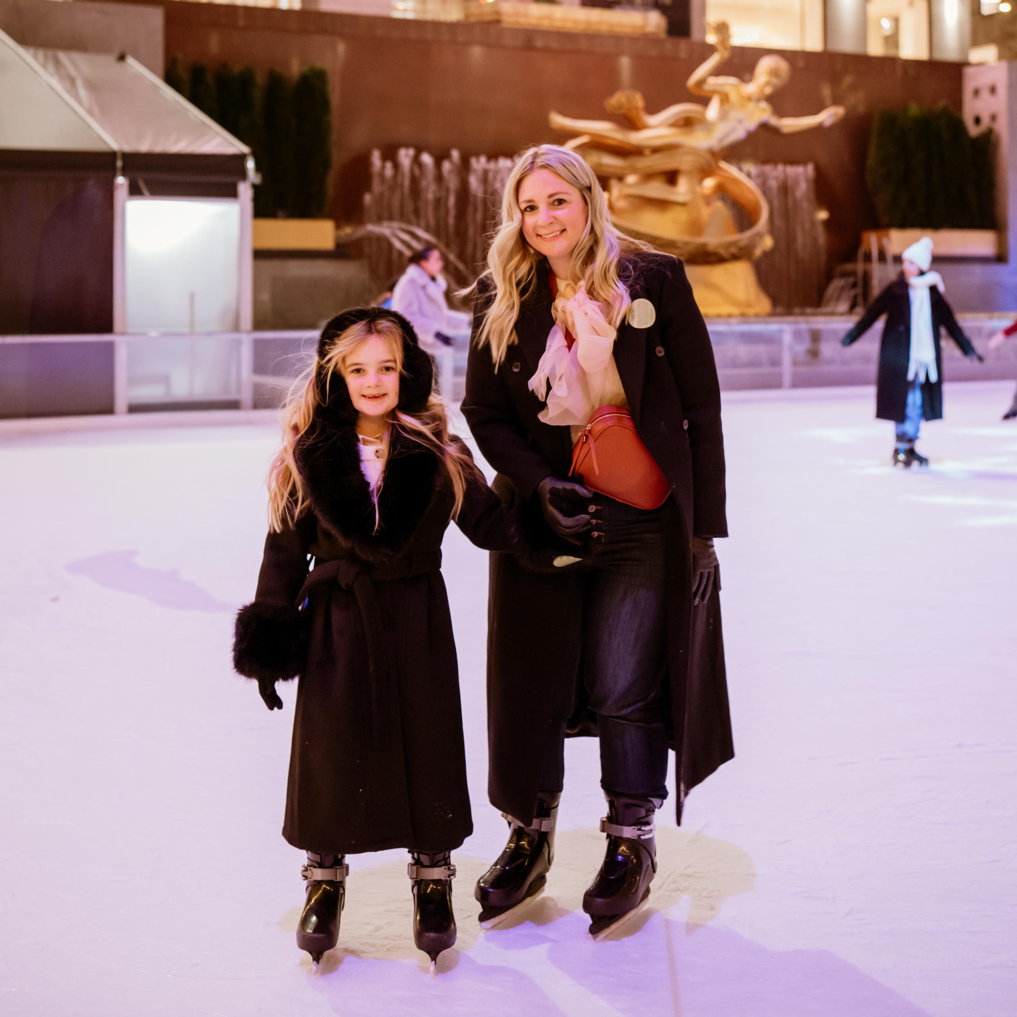 Skaters circle The Rink at Rockefeller Center beneath the golden Prometheus statue and the Christmas Tree.