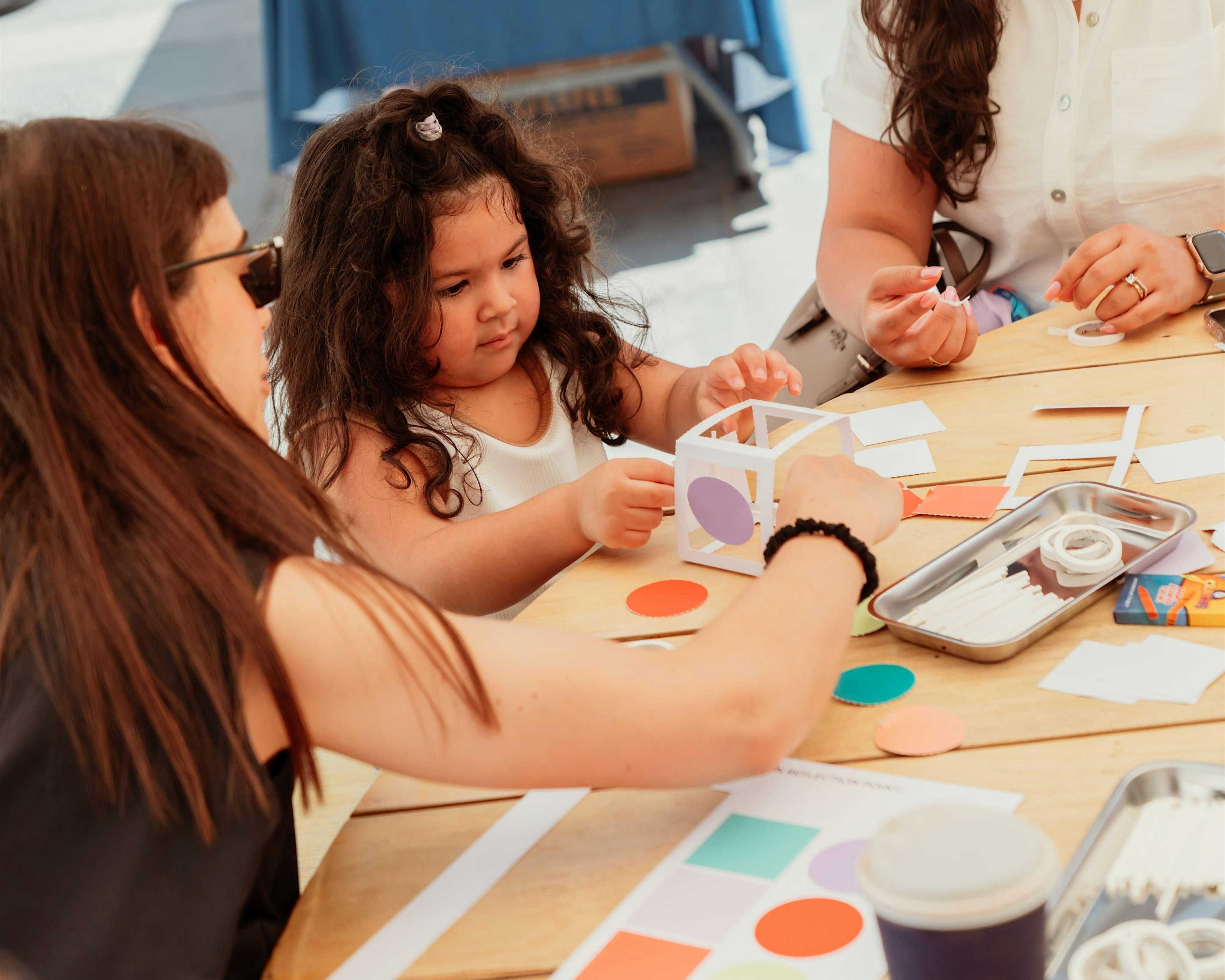 mother and two children doing a craft together