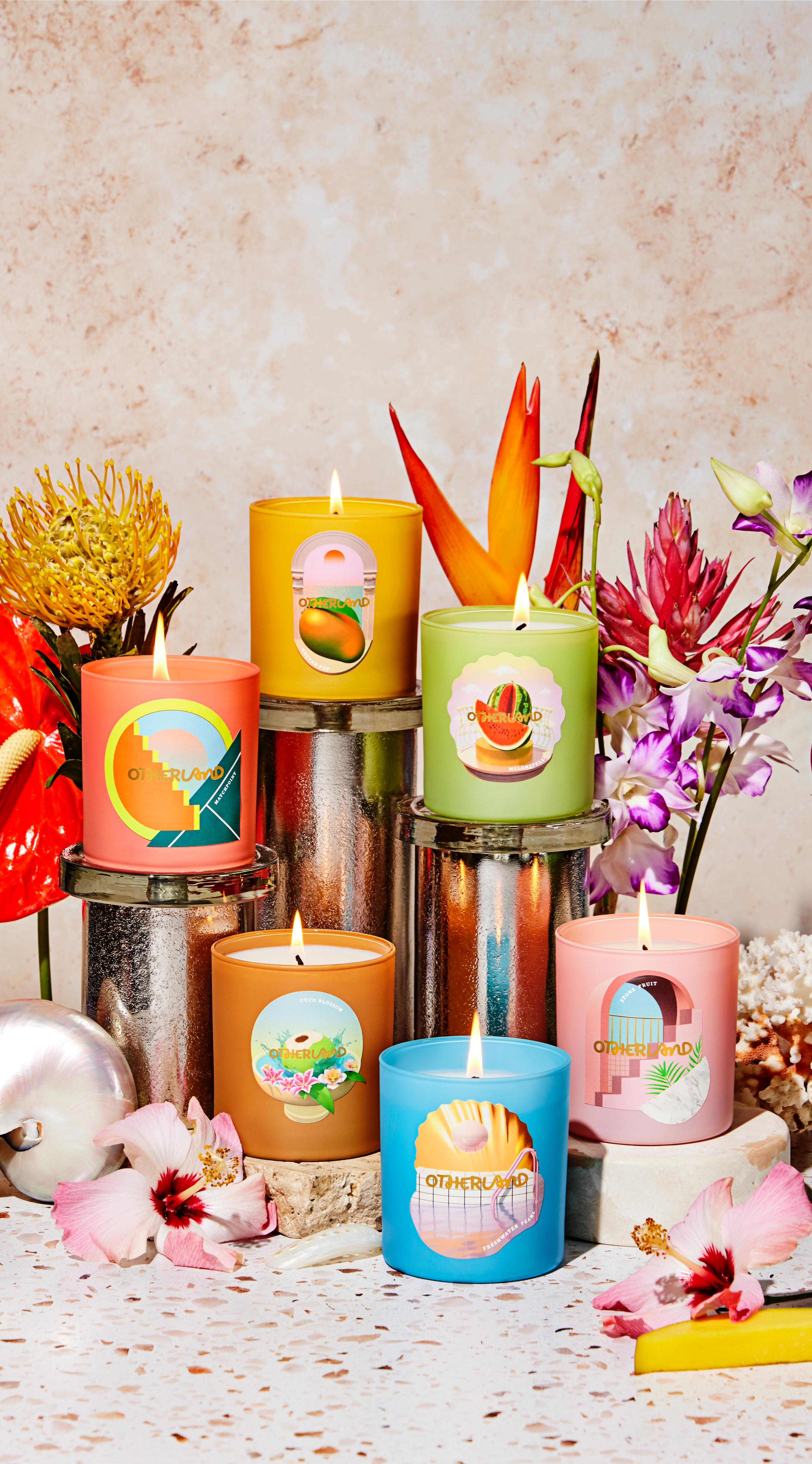 Colorful candles laid across a set-up of flowers 