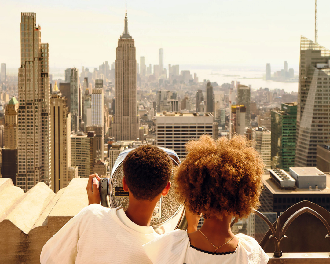 two kids looking out at the new york city skyline