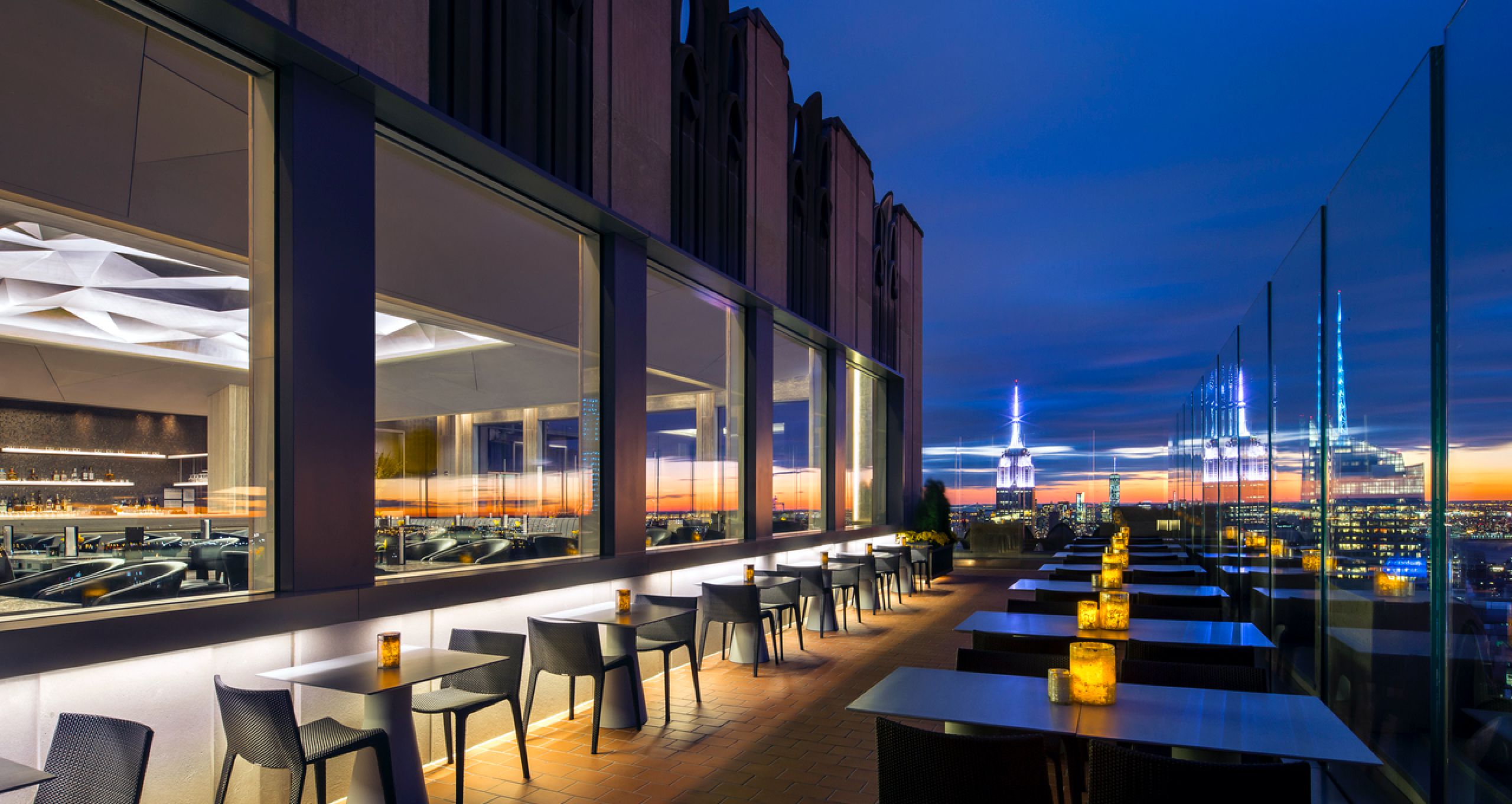 Night skyline views on Manhattan from Rockefeller Center's rooftop bar.