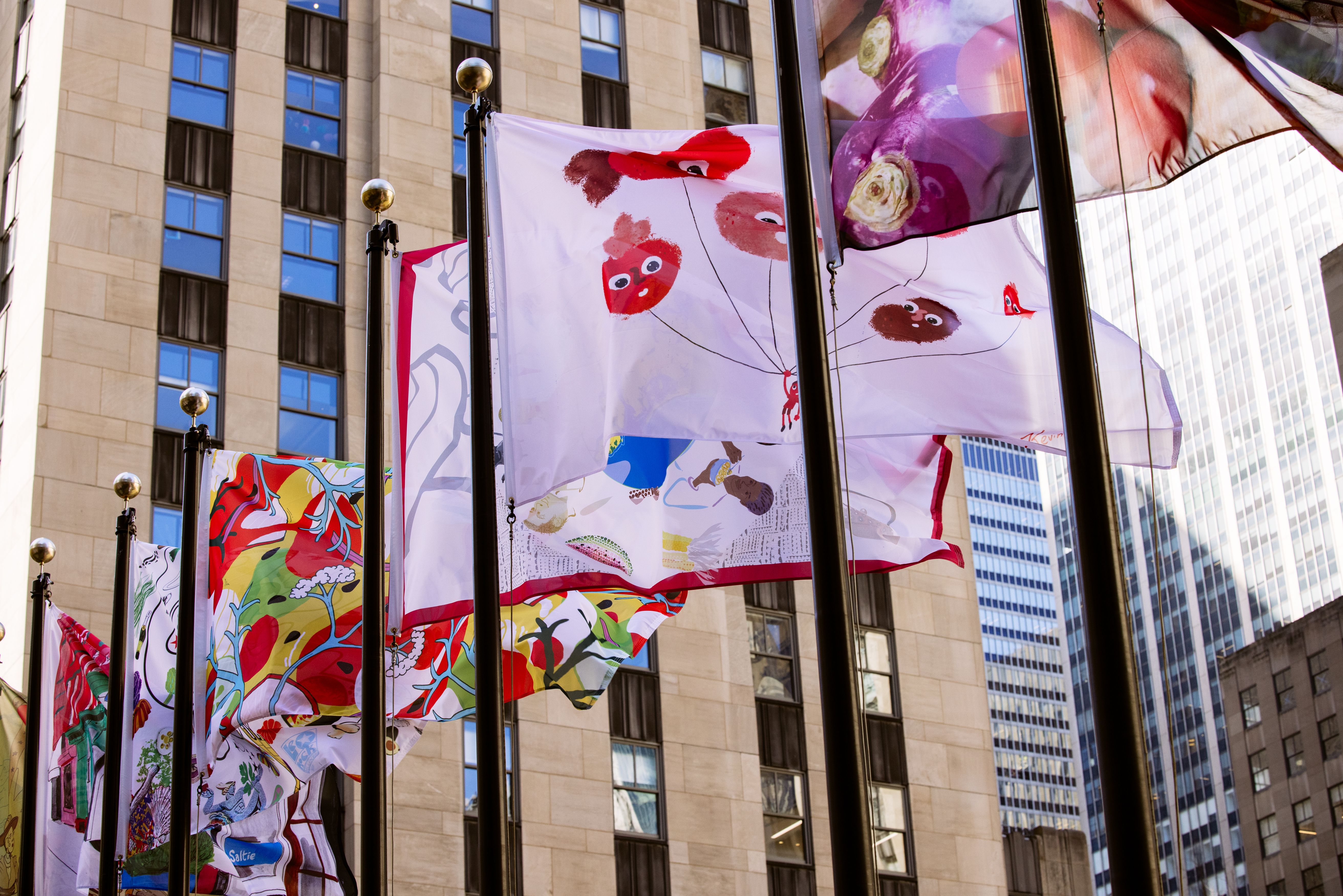 The Flag Project 2023 flags flying over The Rink at Rockefeller Center