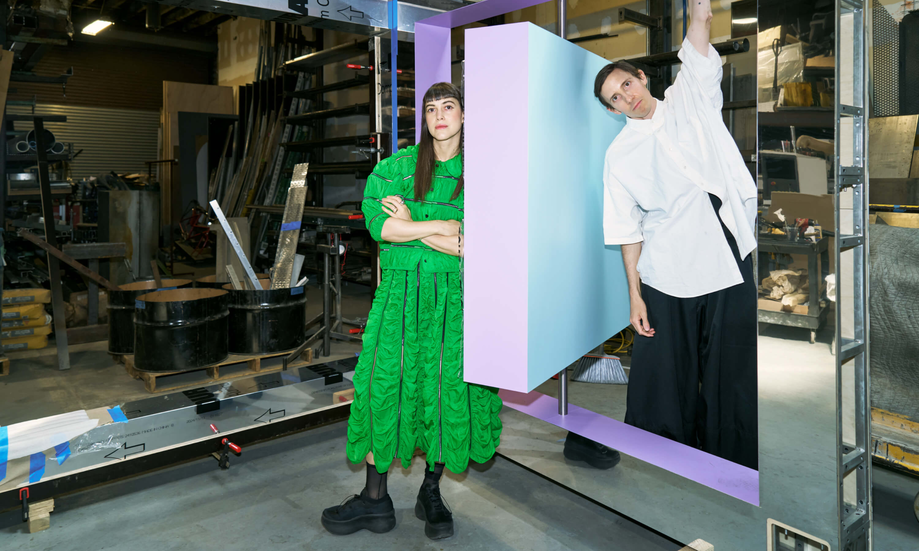 Leta and Wade standing next to one of the pieces used to construct "Reflection Point"