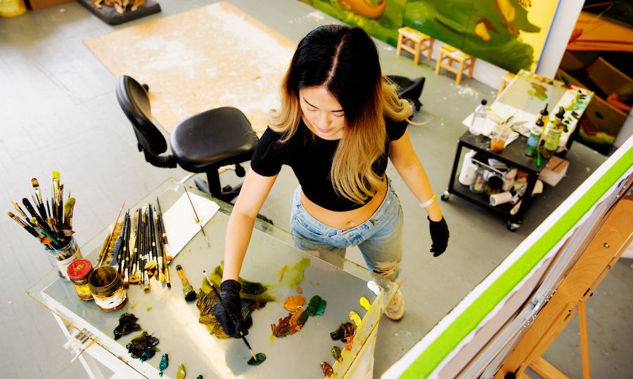 Aerial view of Art in Focus artist Dominique Fung painting in her studio