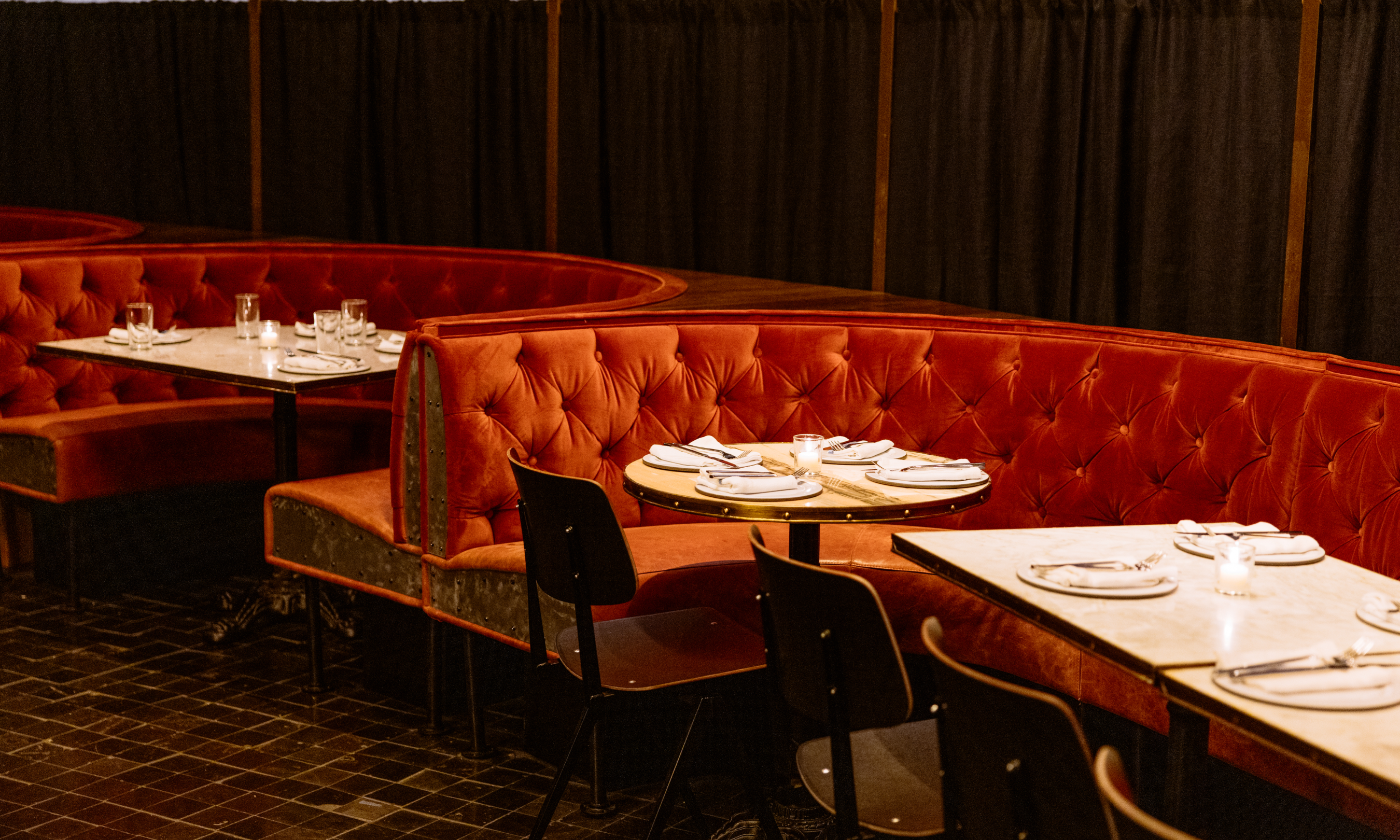 Half-circle booths and tables at Smith & Mills at Rockefeller Center