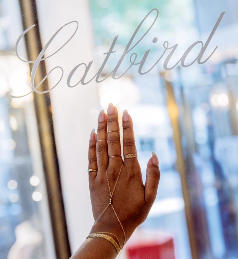 Hand wearing rings and bracelets from Catbird at Rockefeller Center