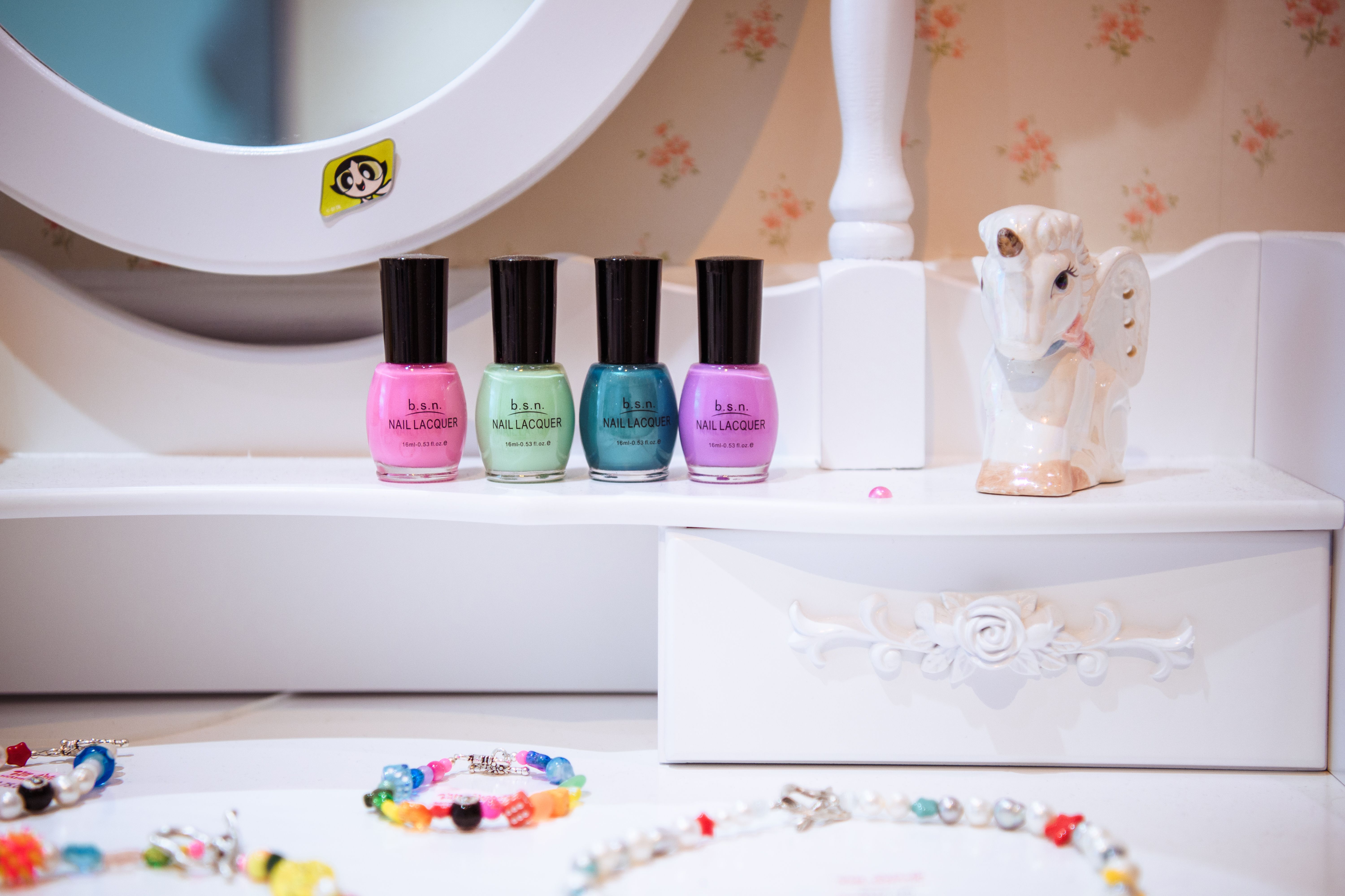 Jewelry and nail polish on a vanity table at Ian Charms at Rockefeller Center